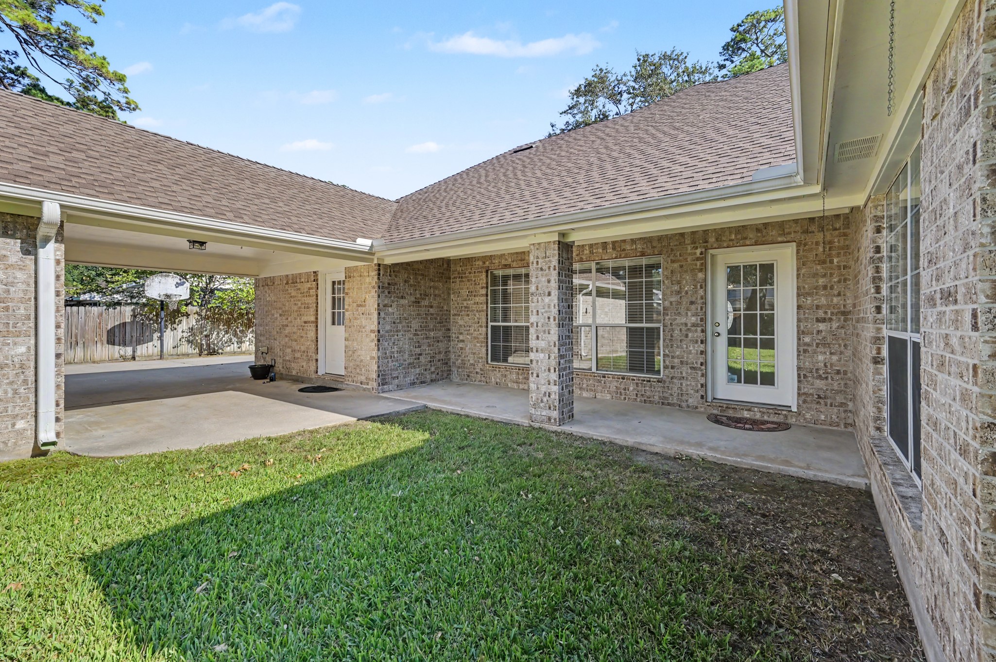 Another view of the spacious covered patio, perfect for outdoor relaxation, with easy access to the backyard from the living room.