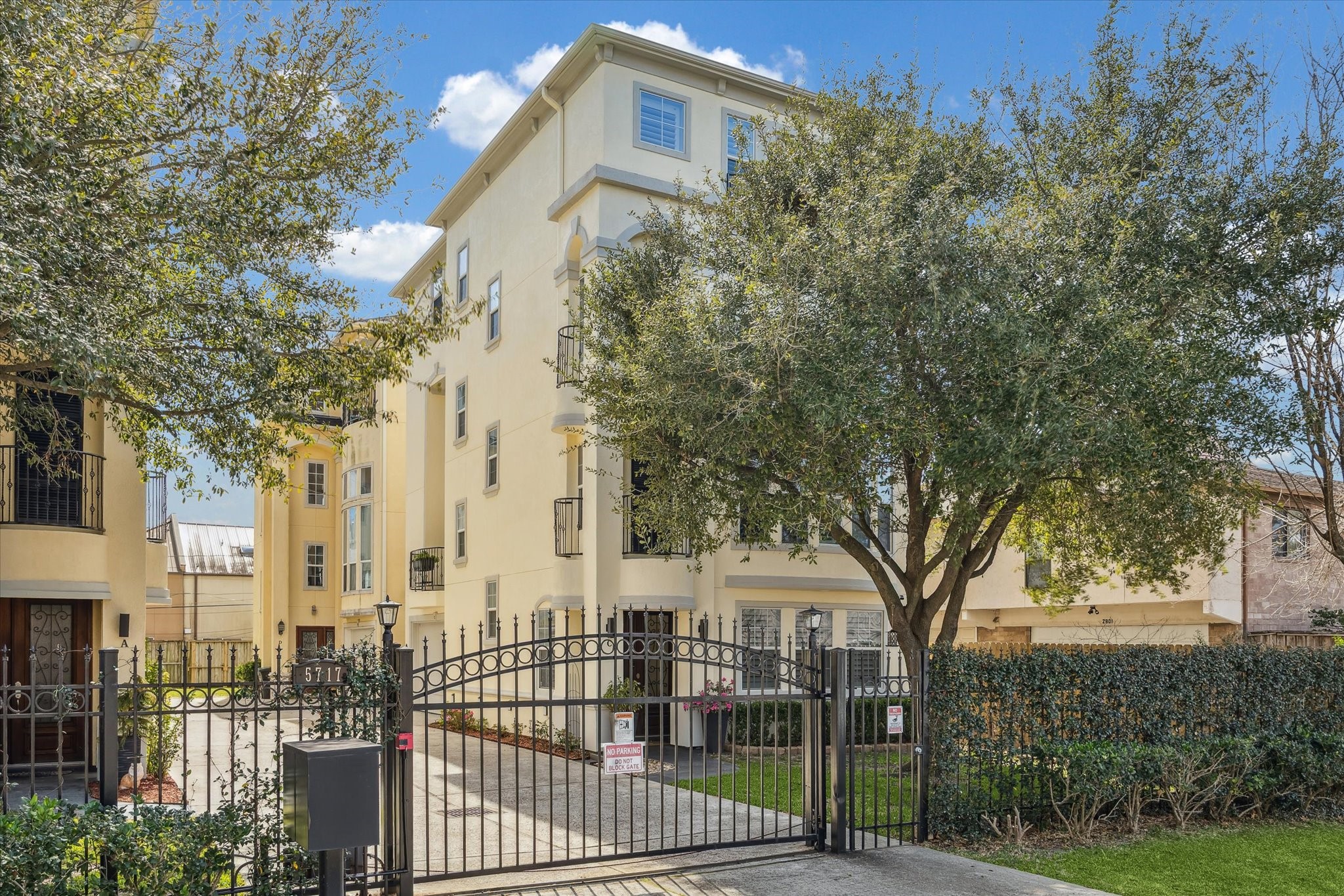 The building is surrounded by mature trees and well-maintained landscaping. T