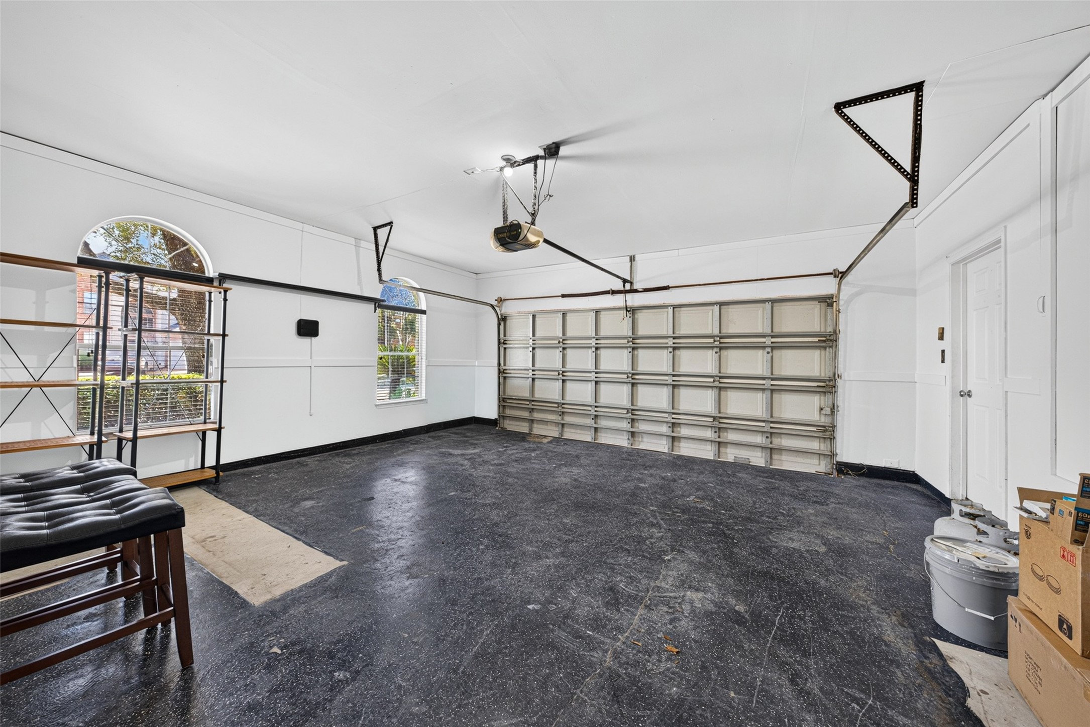 This spacious attached garage offers convenient parking along with ample extra space for a workbench, seasonal storage, or a home gym setup.