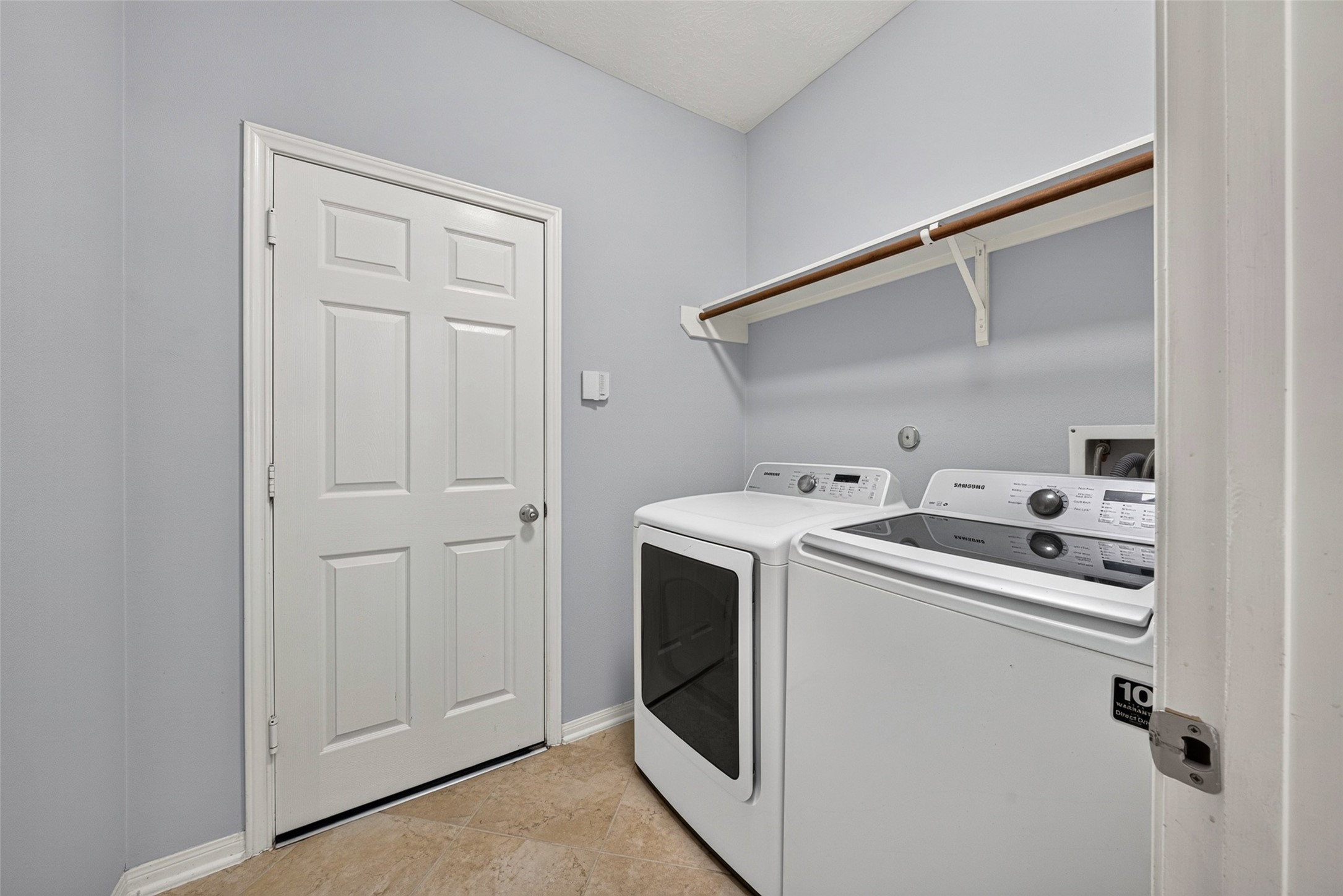 Conveniently located for everyday ease, this dedicated utility room provides built-in washer and dryer connections with space for side-by-side units and overhead storage.