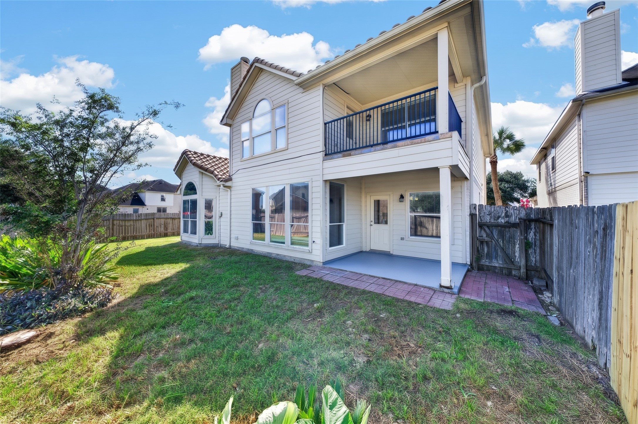 This massive, fully fenced backyard serves as your own private outdoor sanctuary, complete with a covered patio ideal for shaded relaxation or alfresco dining.