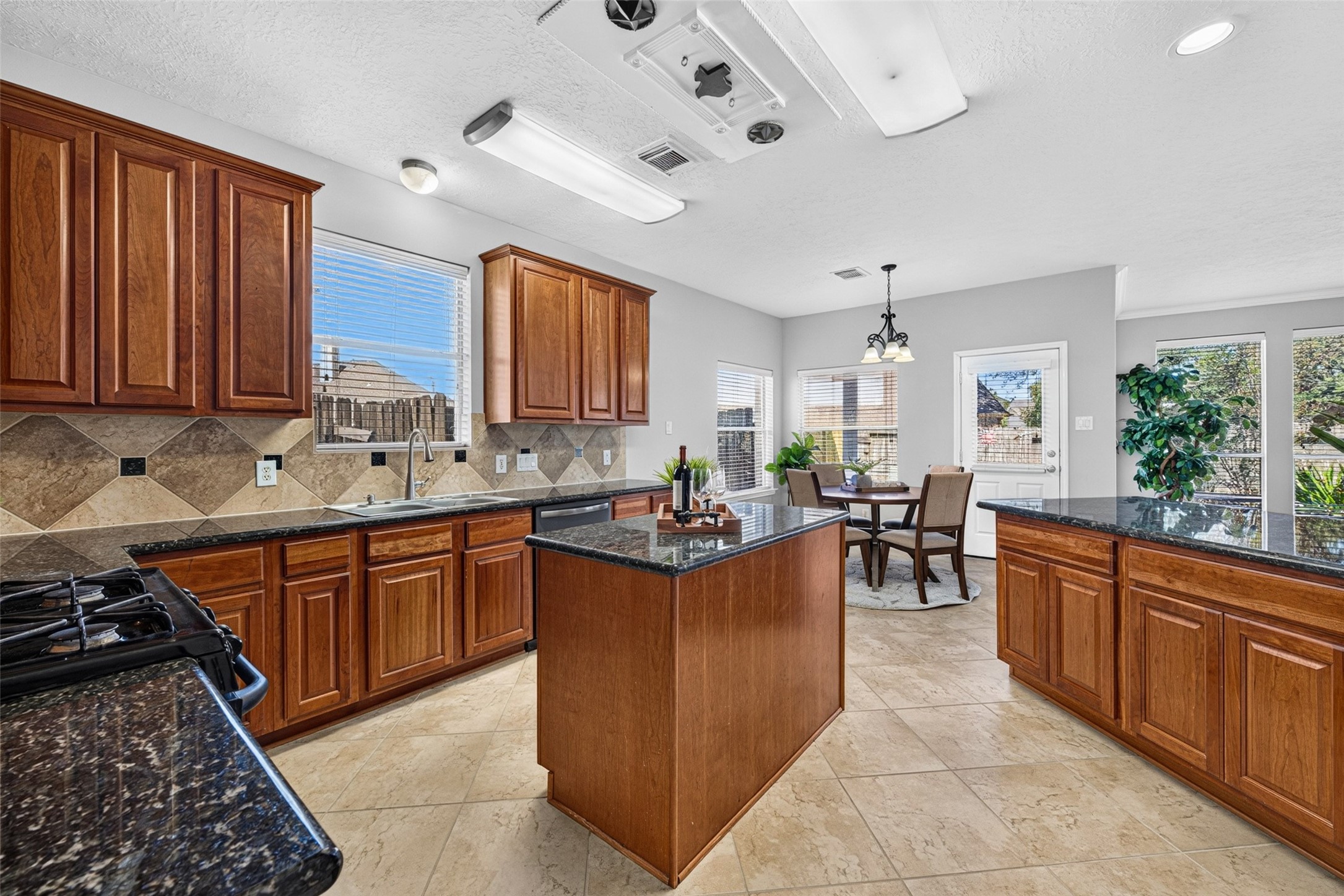 Crafted with love, the heart of this kitchen showcases custom-built wood cabinetry that provides both beauty and endless storage for family recipes.