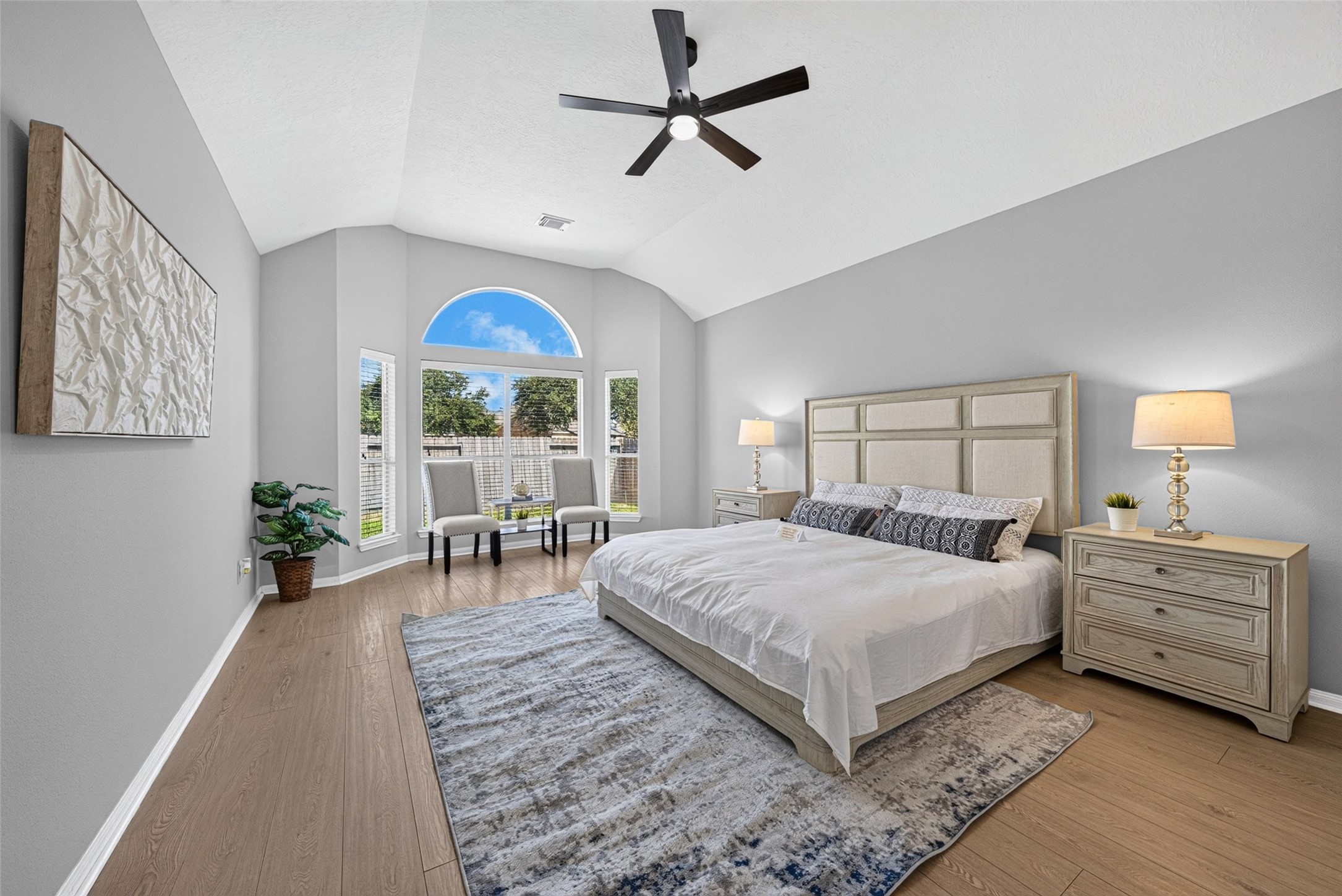 Tucked away on the first floor, the primary bedroom is a serene sanctuary designed for pure rest and relaxation.