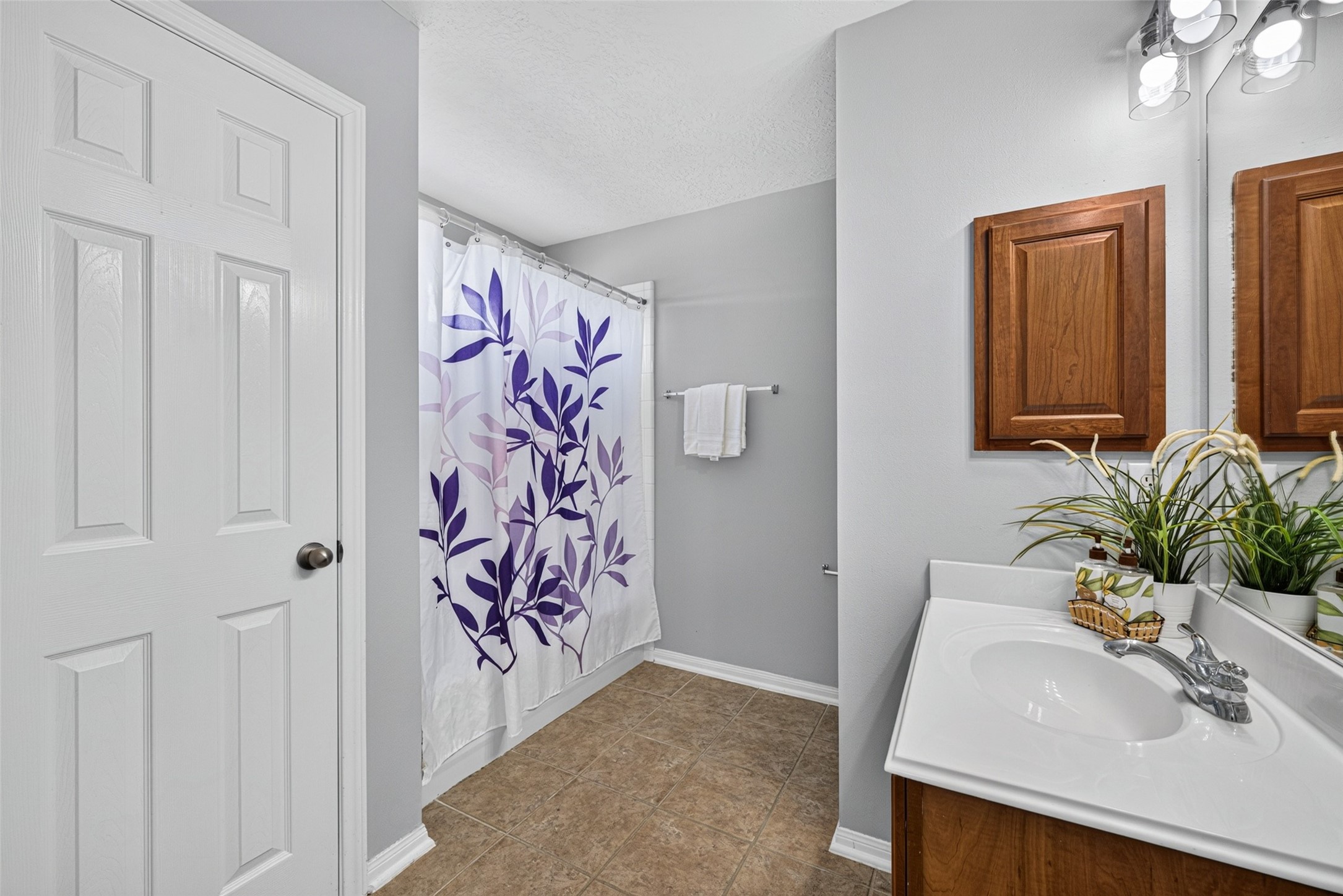 This upstairs ensuite bathroom offers both style and convenience for the second primary bedroom.