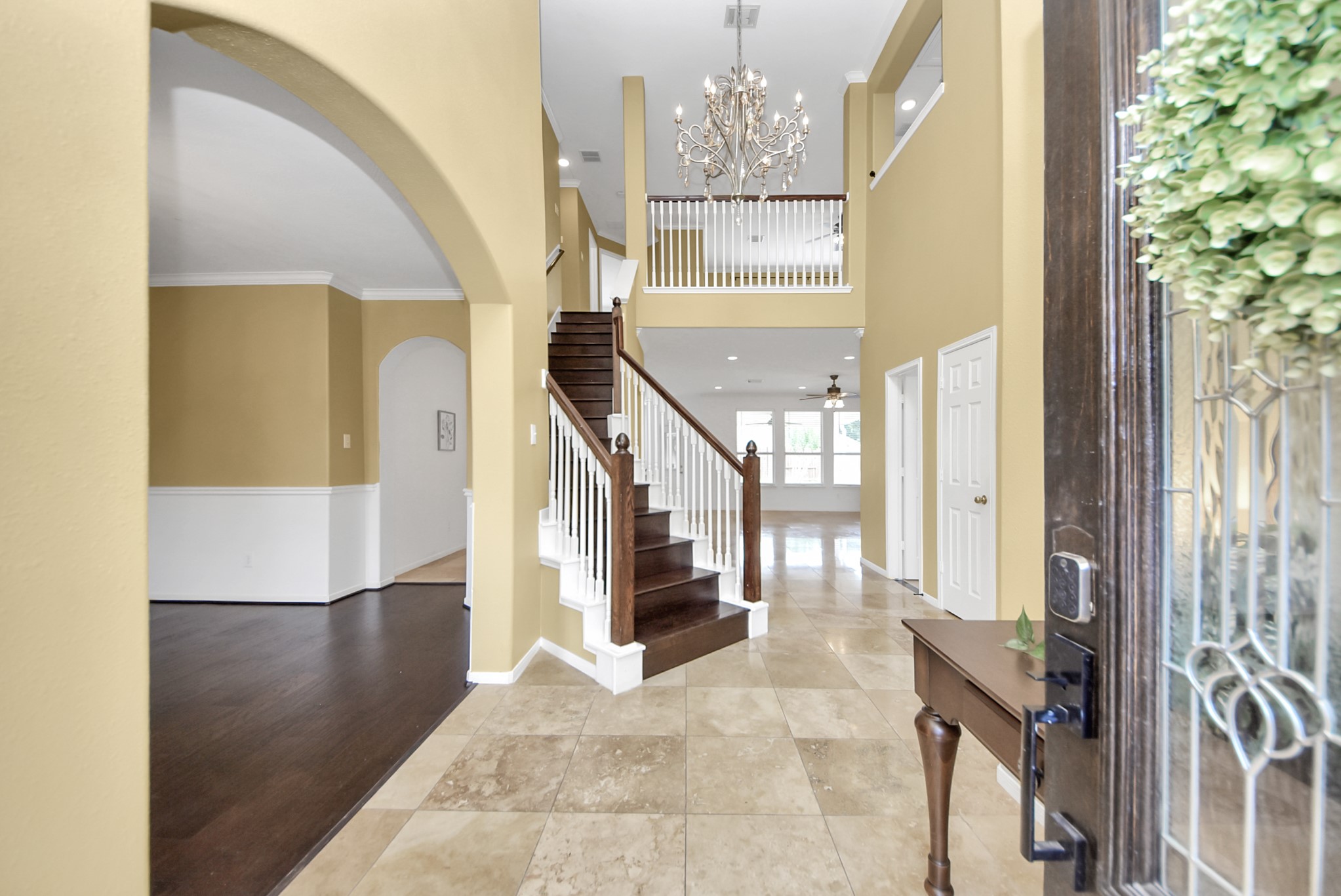Step inside to a soaring two-story foyer and elegant staircase that creates a sense of openness while drawing your eye toward the thoughtfully designed spaces beyond.
