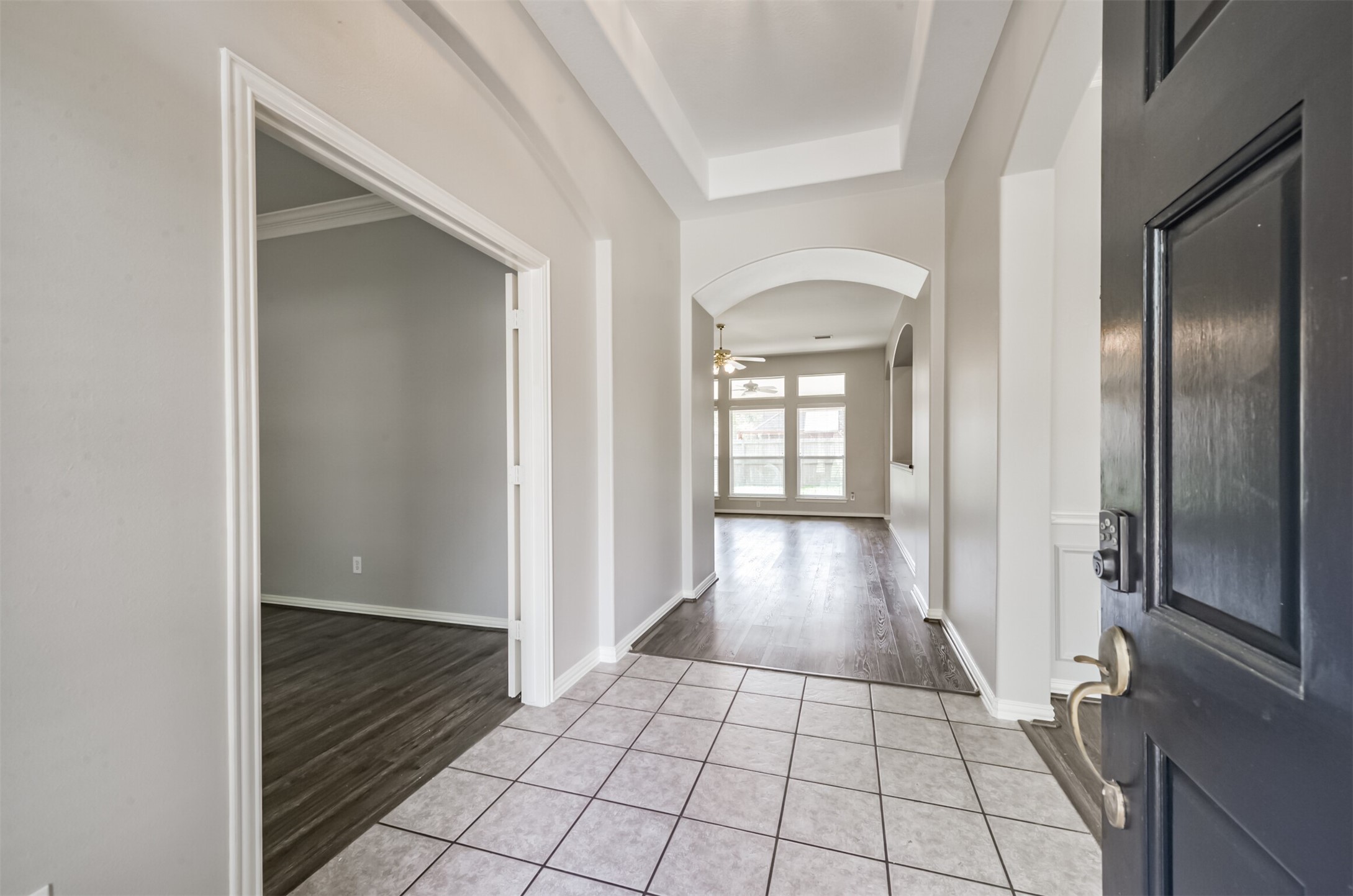 Entry with tile floors and high tray ceiling.  Study with french doors and formal dining off entry.