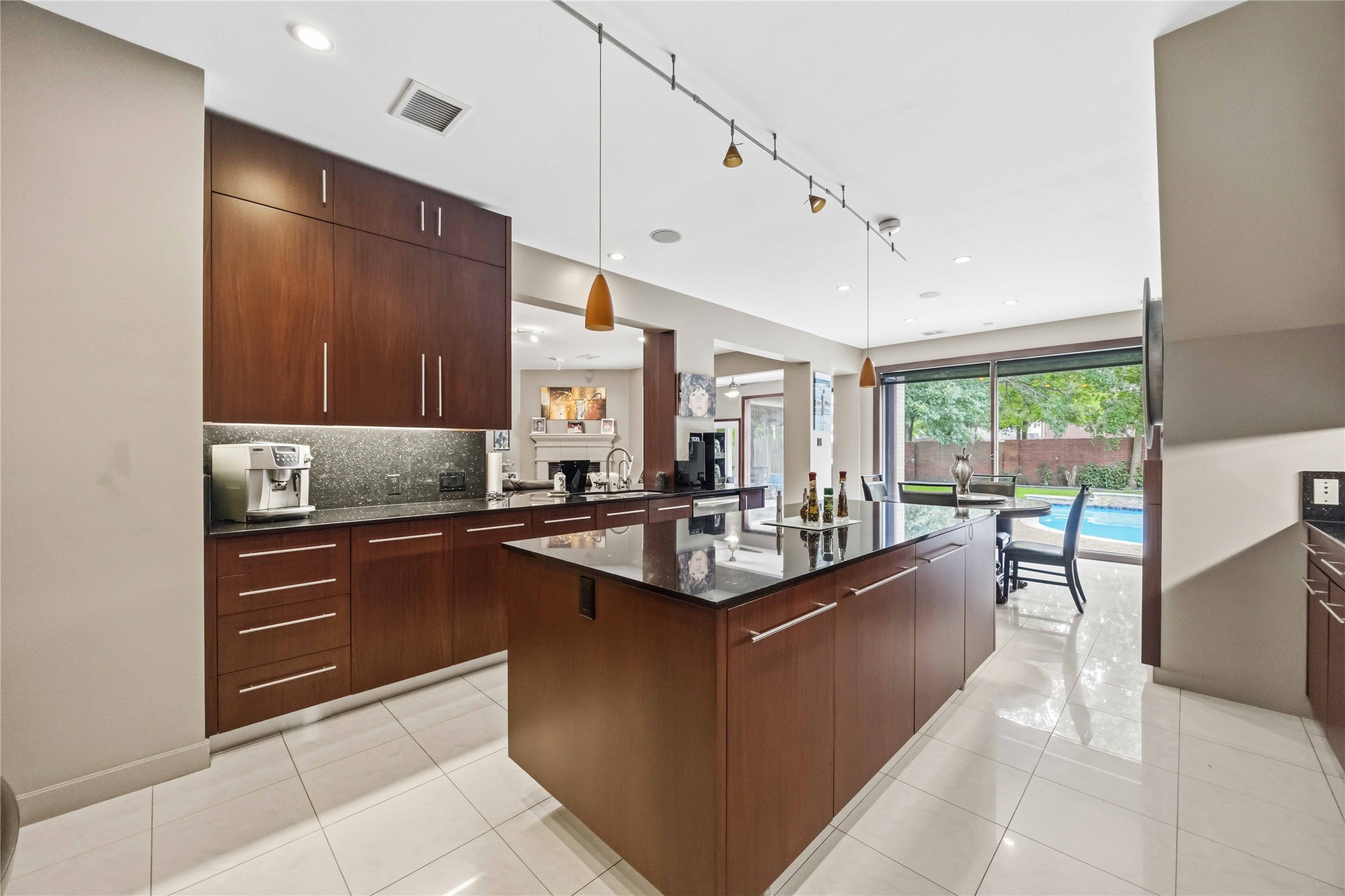 The open kitchen layout flows naturally into a bright breakfast alcove bounded by large rear-facing windows.