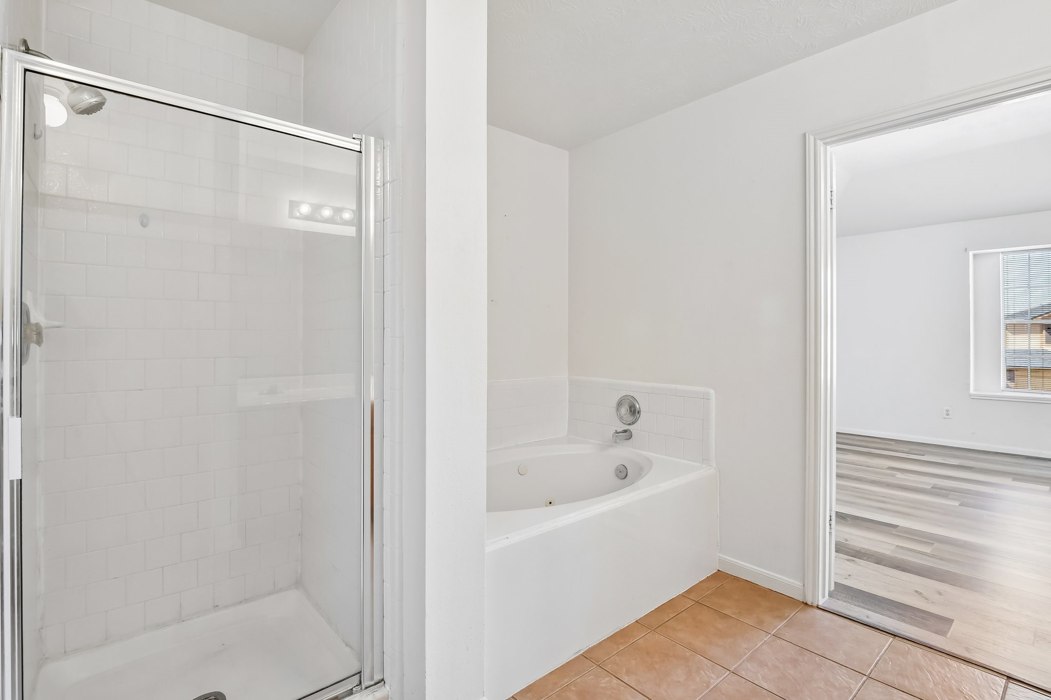 Primary bath jetted tub and separate shower.
