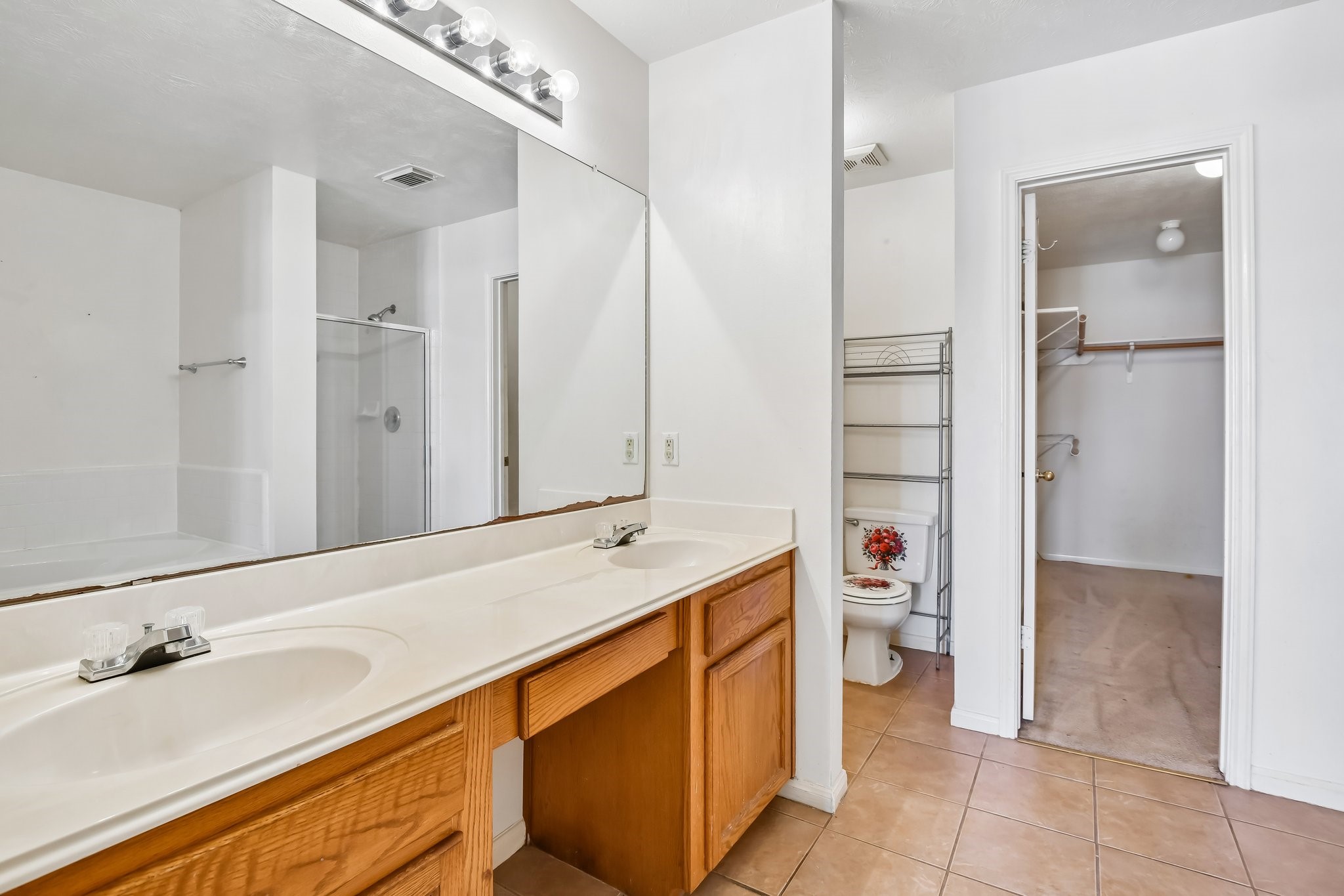 Primary bathroom with double sinks. jetted tub and separate shower.