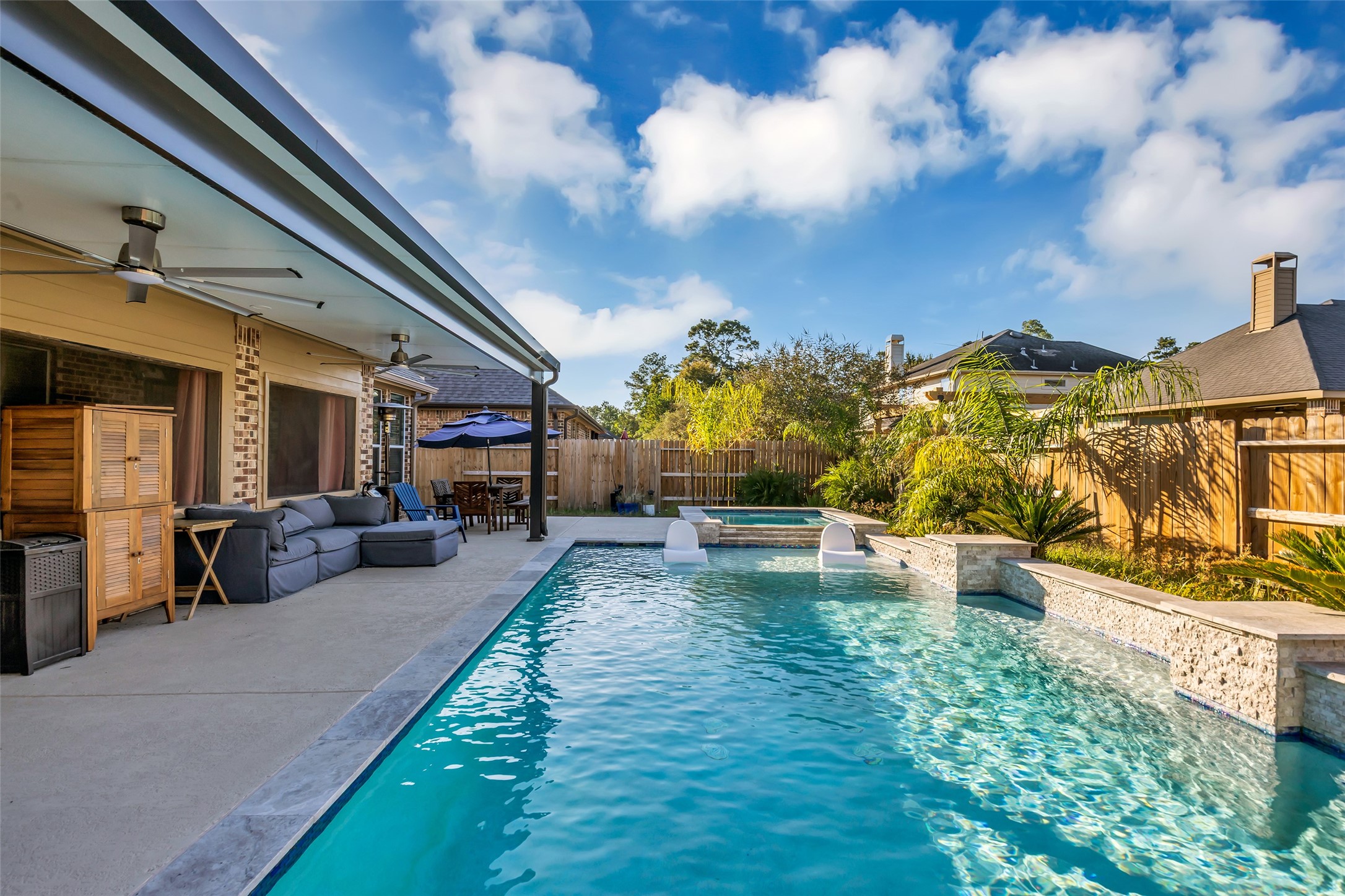 Experience luxurious outdoor living with a sparkling pool, spacious patio, and stylish seating area perfect for entertaining or relaxing.