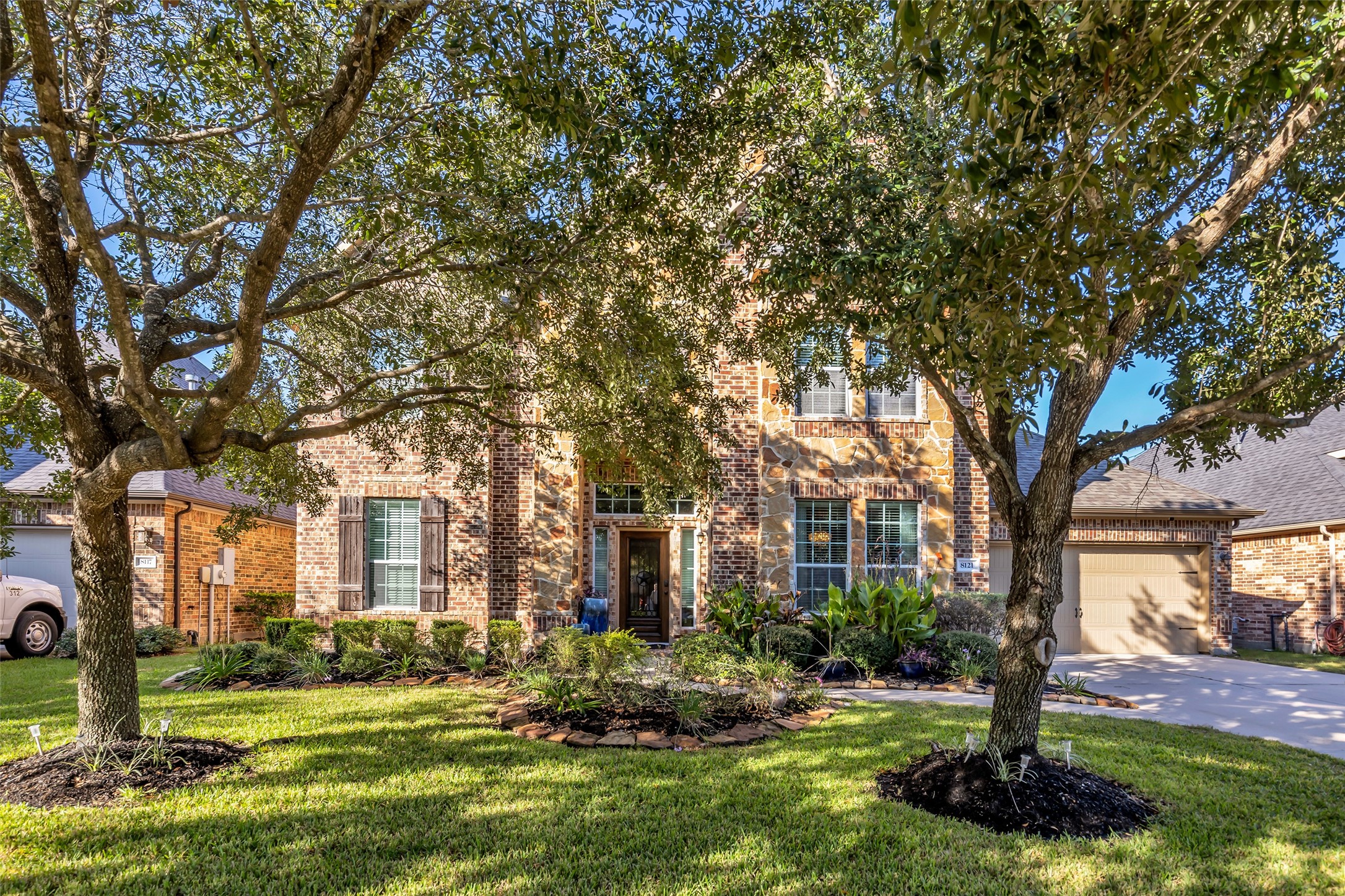 Charming brick home with lush landscaping, mature trees, and inviting curb appeal in a serene neighborhood. Charming brick home with lush landscaping, mature trees, and inviting curb appeal in a serene neighborhood.