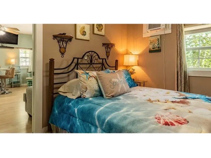 Charming bedroom in the Doc Holiday with cozy decor, natural light, and a seamless flow into the living area for a warm and inviting atmosphere.