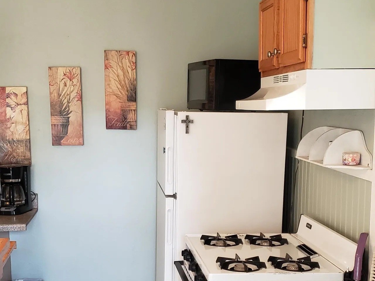 Cozy kitchen in the Laurel Anne featuring charming decor, ample storage, and essential appliancesperfect for creating delicious meals in a welcoming space.