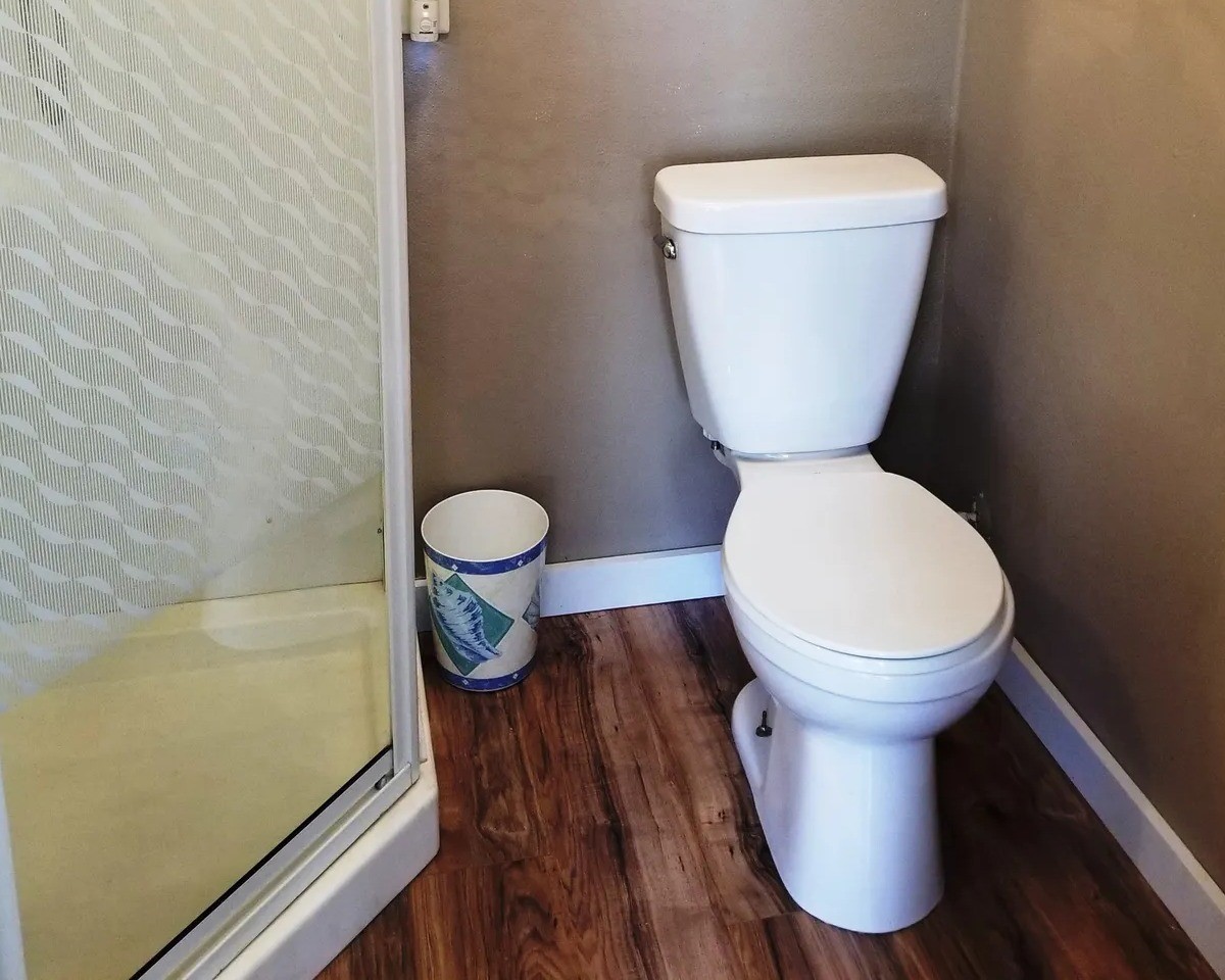Compact and efficient bathroom in the Tackle Box featuring a modern shower and sleek design, perfect for maximizing space and functionality.
