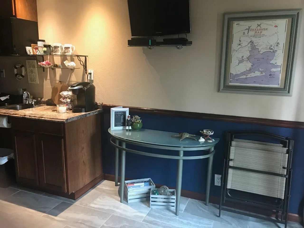 Welcome to Captain's Quarters a cozy, nautical-themed retreat featuring a compact kitchenette, elegant decor, and a relaxing ambiance. Ideal for unwinding or entertaining.