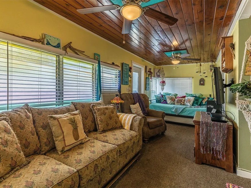 Charming living room in the Saltwater Gypsy with coastal decor, cozy seating, and a relaxing ambiance. Perfect for unwinding by the sea.