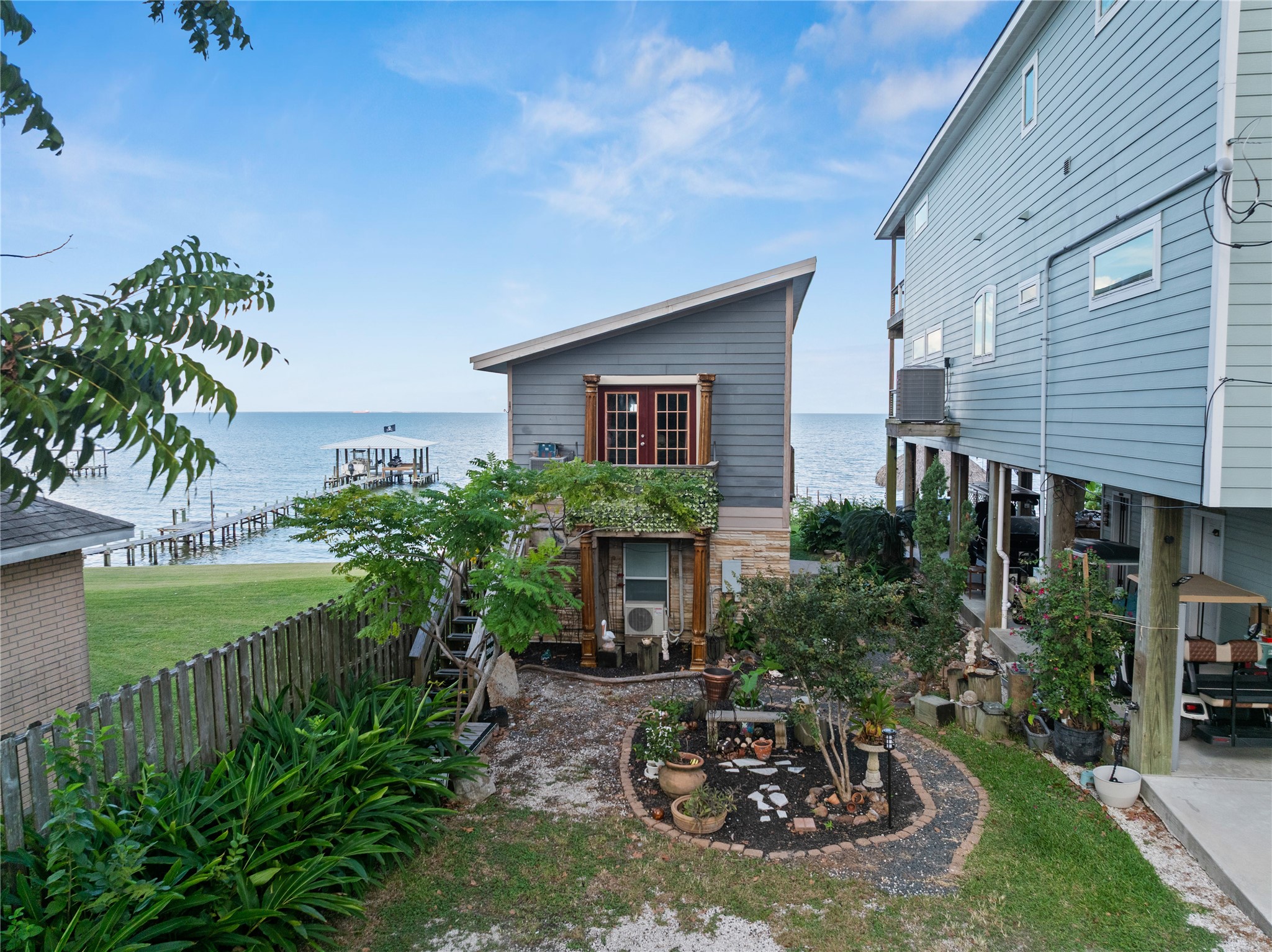 This photo of The LaView Suite offers stunning views of the bay with direct access to a private pier. The cozy garden adds a touch of tranquility.