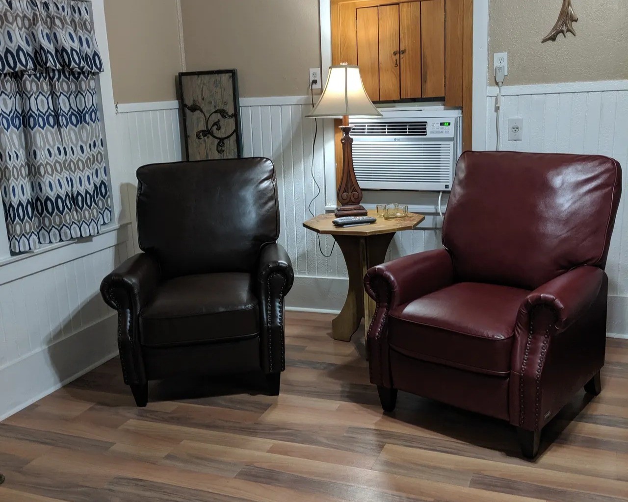 Cozy and inviting, this living space in the Tejas features two plush armchairs, warm wood accents, and ample natural light. Perfect for relaxation and comfort.
