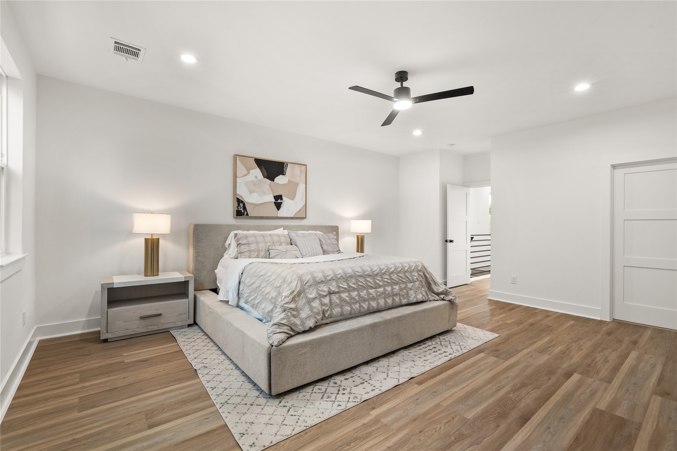 A second view of the primary suite highlights its thoughtful layout, with recessed lighting throughout and
doors leading to the landing and the primary bath, keeping the retreat private yet connected.