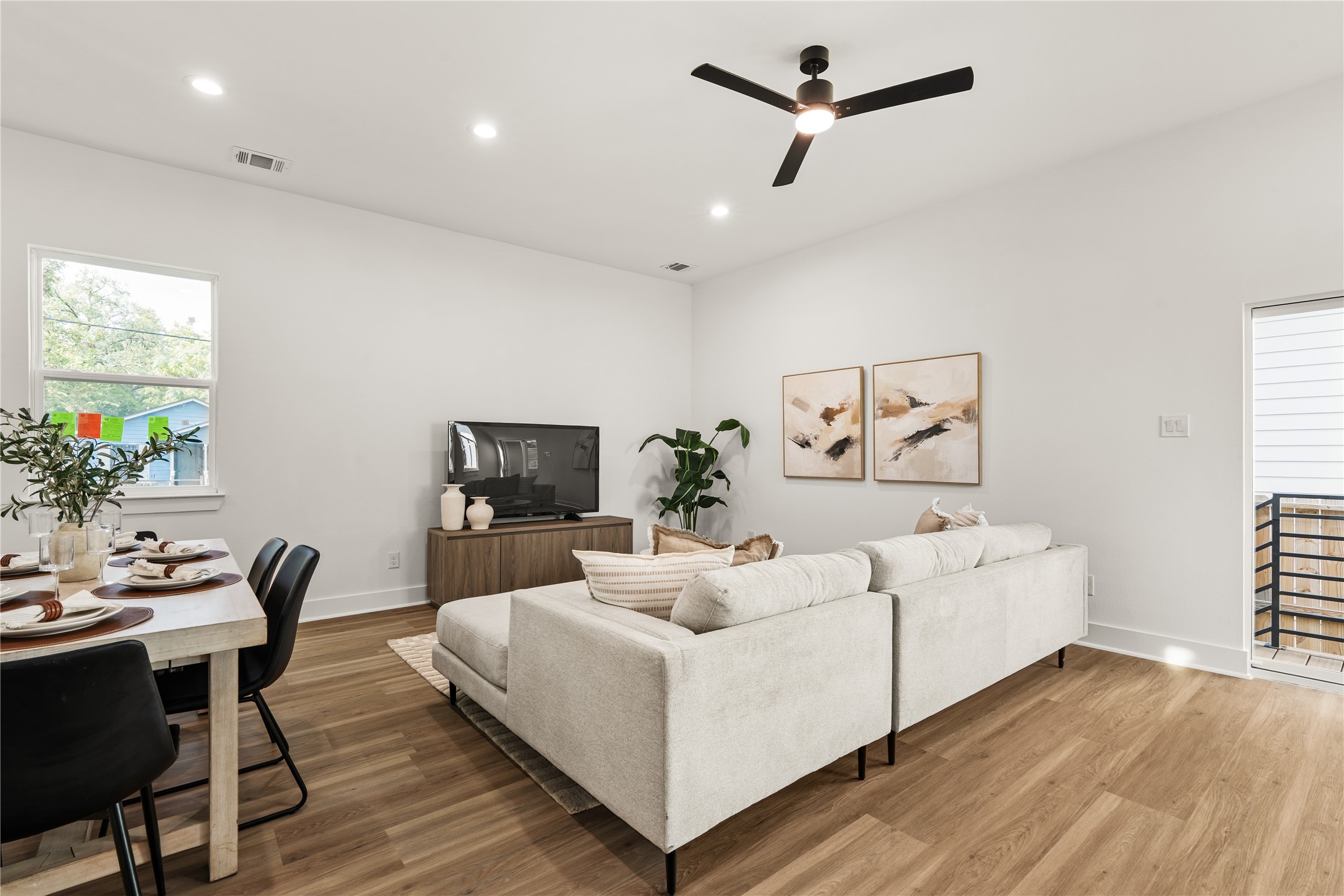 The living room's sliding glass door opens to a covered back porch with steps down to the fenced backyard,
extending everyday living outdoors with ease.