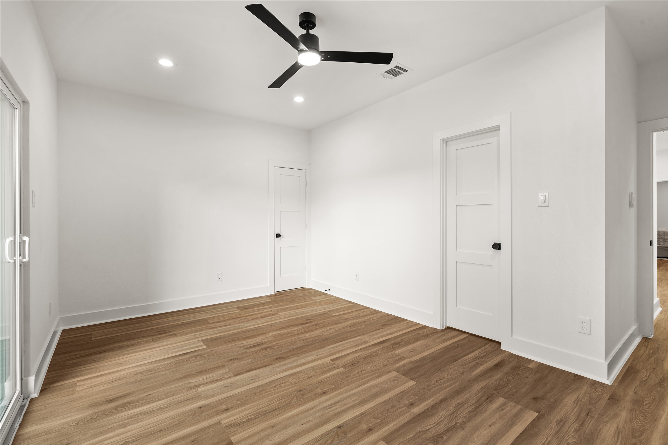 Another view shows the room's closet and direct access to a Jack-and-Jill bath, along with generous wall
space for furnishings and wide-plank flooring that carries seamlessly from room to room.