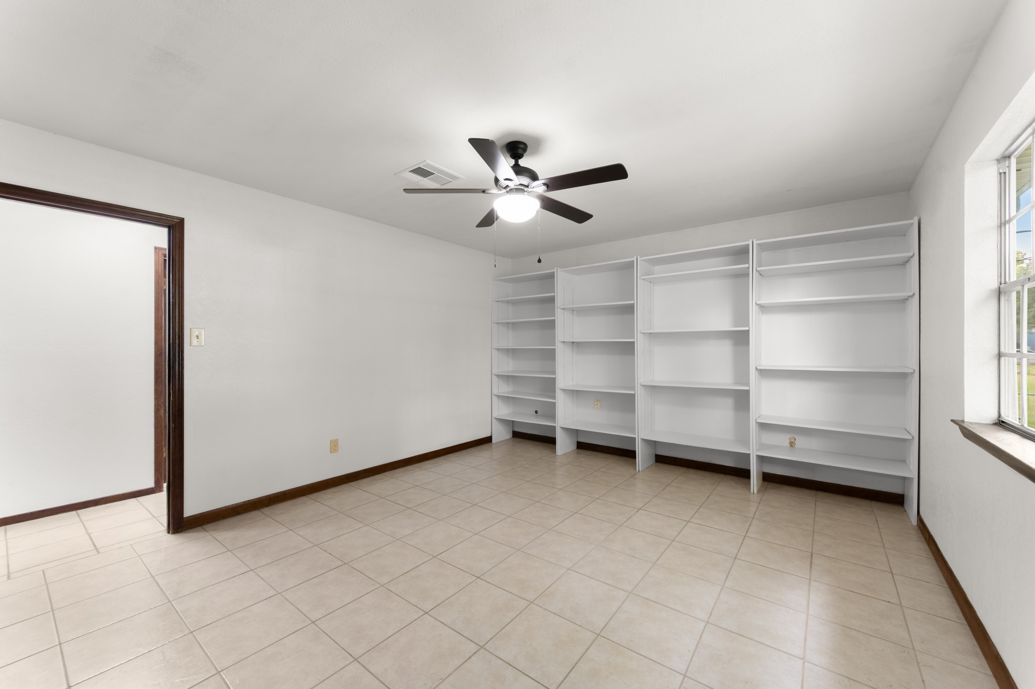 Extensive removable shelving provides excellent space for books, collectibles, or organized storage, adding versatility to the primary bedroom.