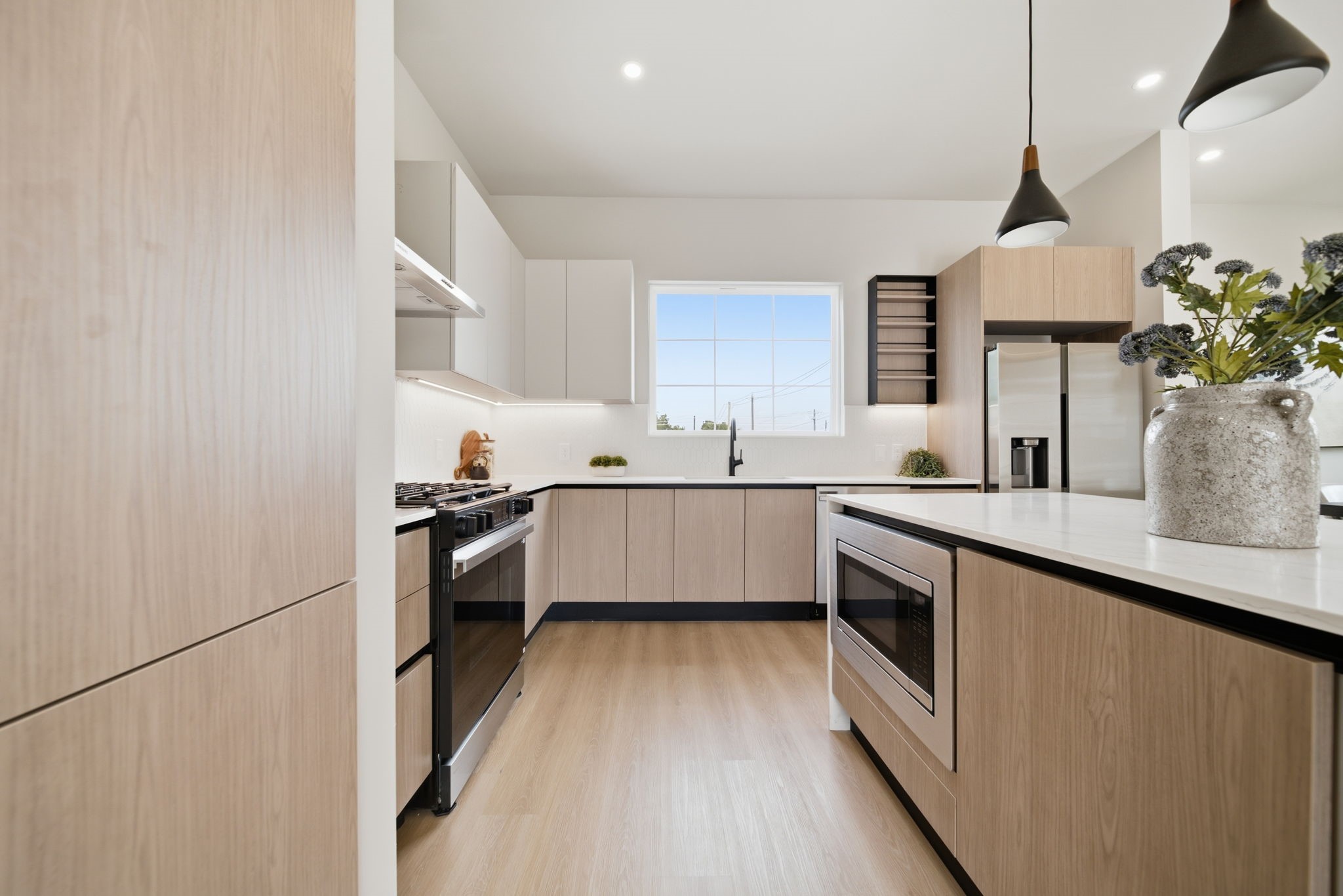 This kitchen features efficient finished such as soft-close cabinets & drawers, under-cabinet lighting, and a pot filler.