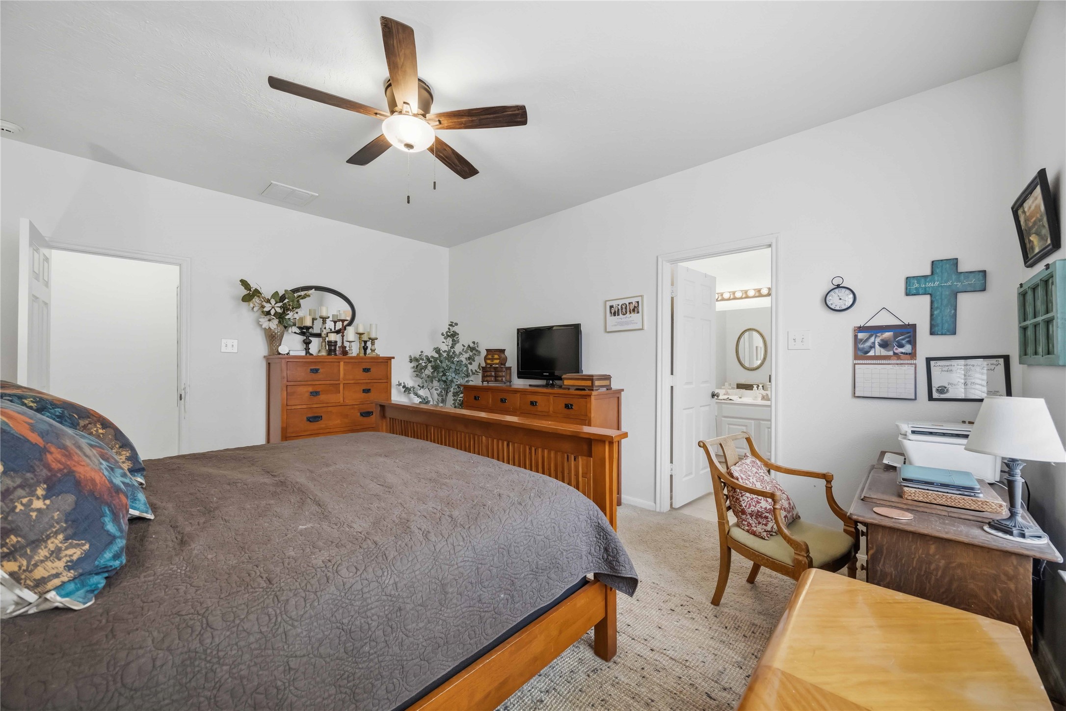 Another view of the primary bedroom highlighting its spacious layout and convenient access to the ensuite bathroom.