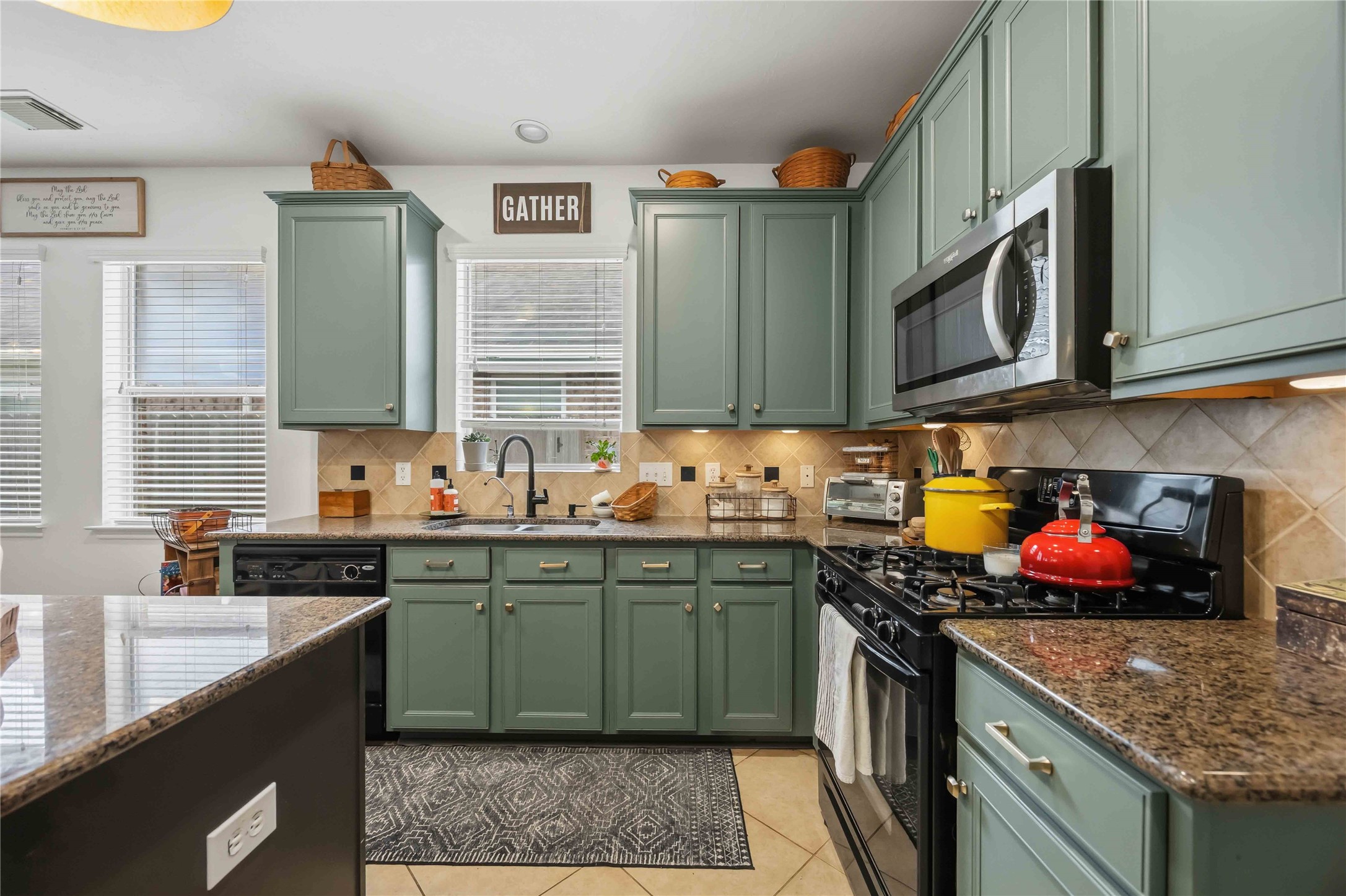 Well-equipped kitchen with a gas range, built-in microwave, and a dishwasher.