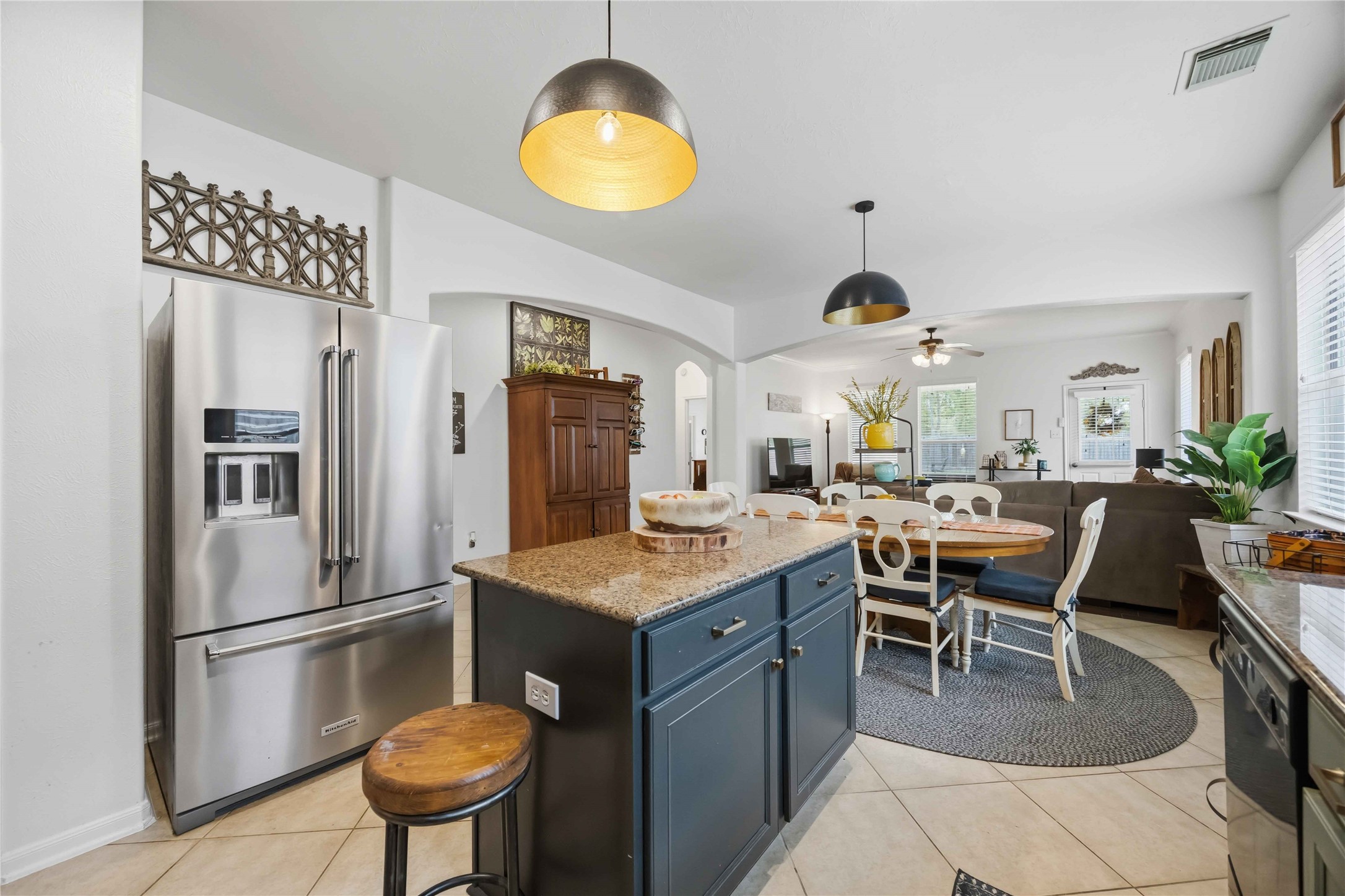 Kitchen island with granite countertops and additional storage, overlooking the breakfast area and family room.