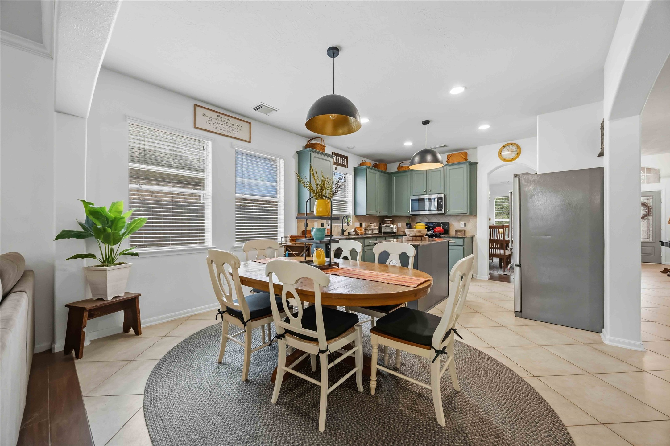 Another view of the breakfast area highlighting pendant lighting and the open layout connecting the living spaces.