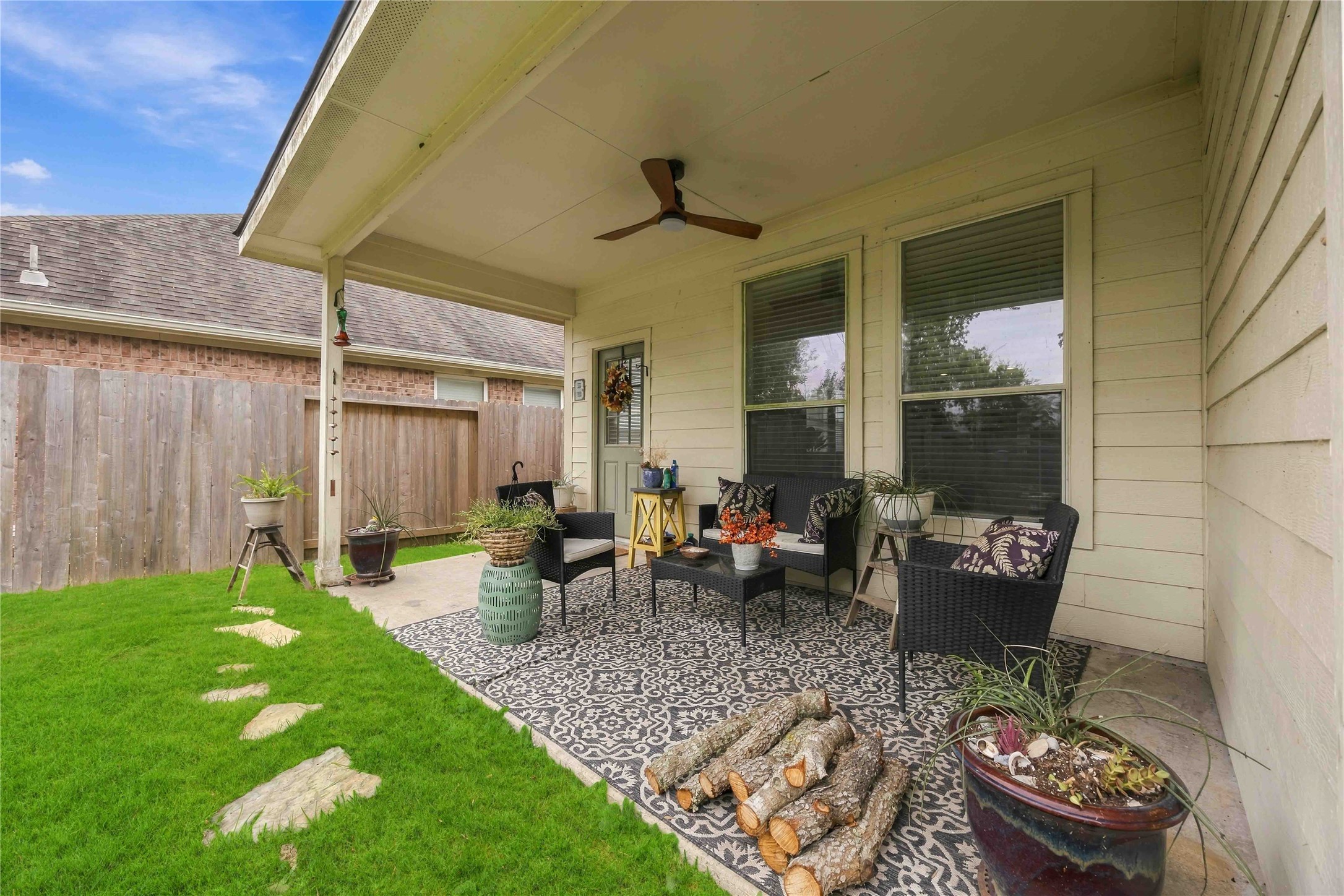 Another patio angle highlighting the shaded outdoor space and direct access to the home.