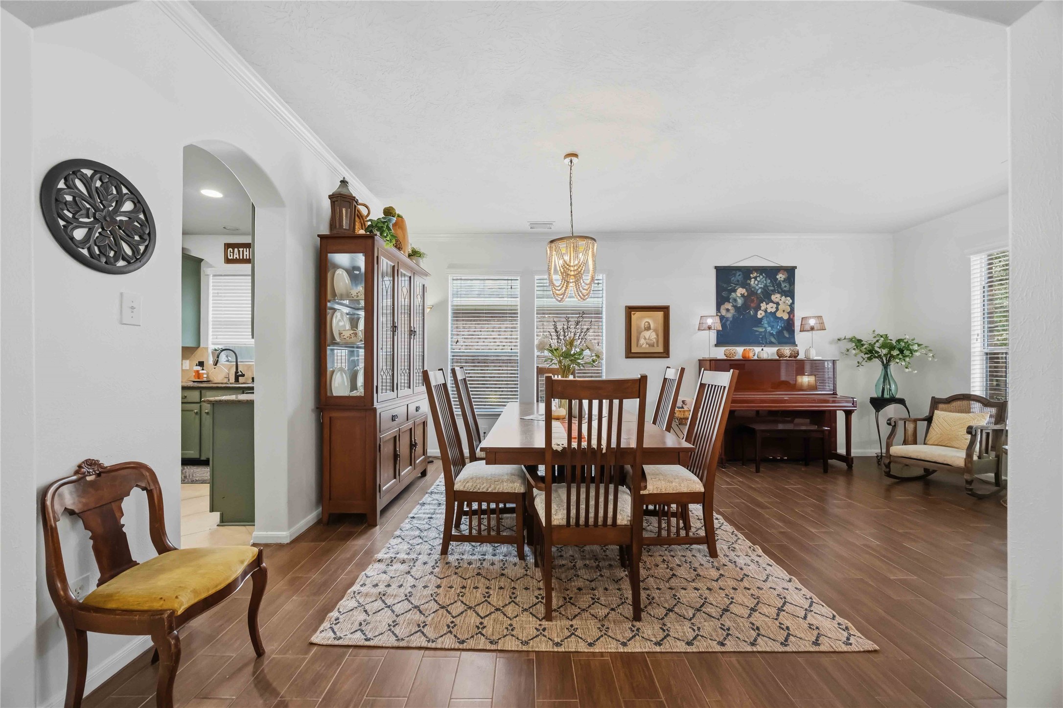 Spacious formal dining area featuring a decorative chandelier and convenient access to the kitchen.