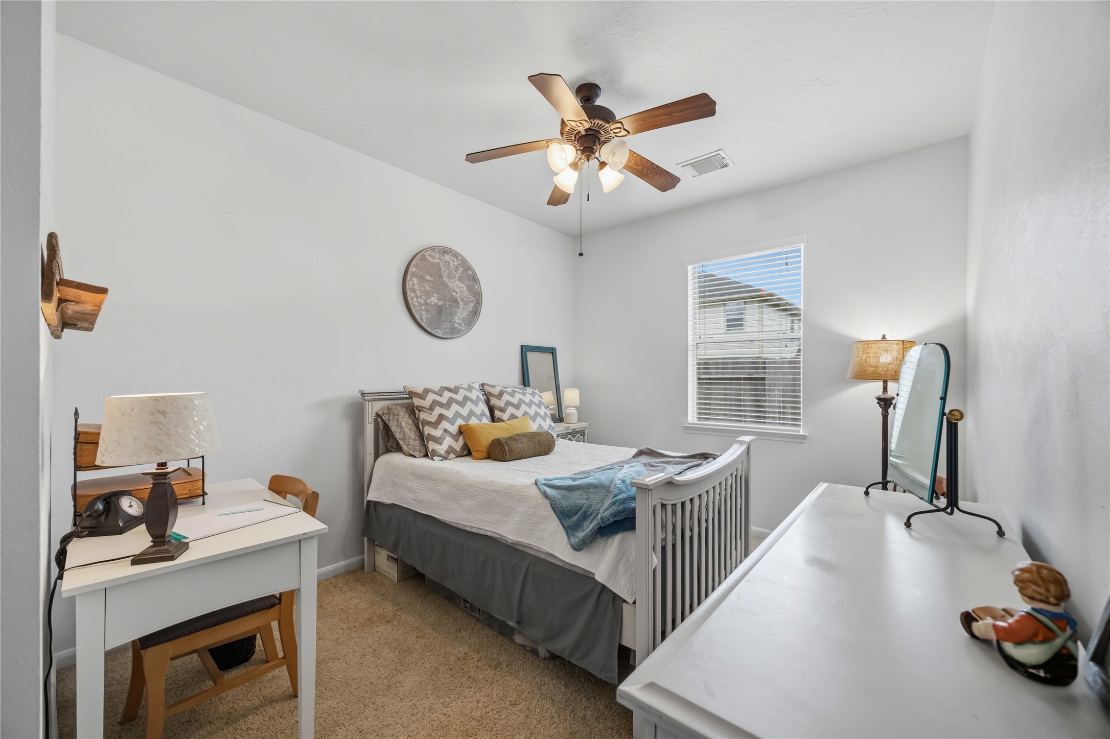 Another secondary bedroom with comfortable proportions, soft carpeting, and a ceiling fan with light fixture.