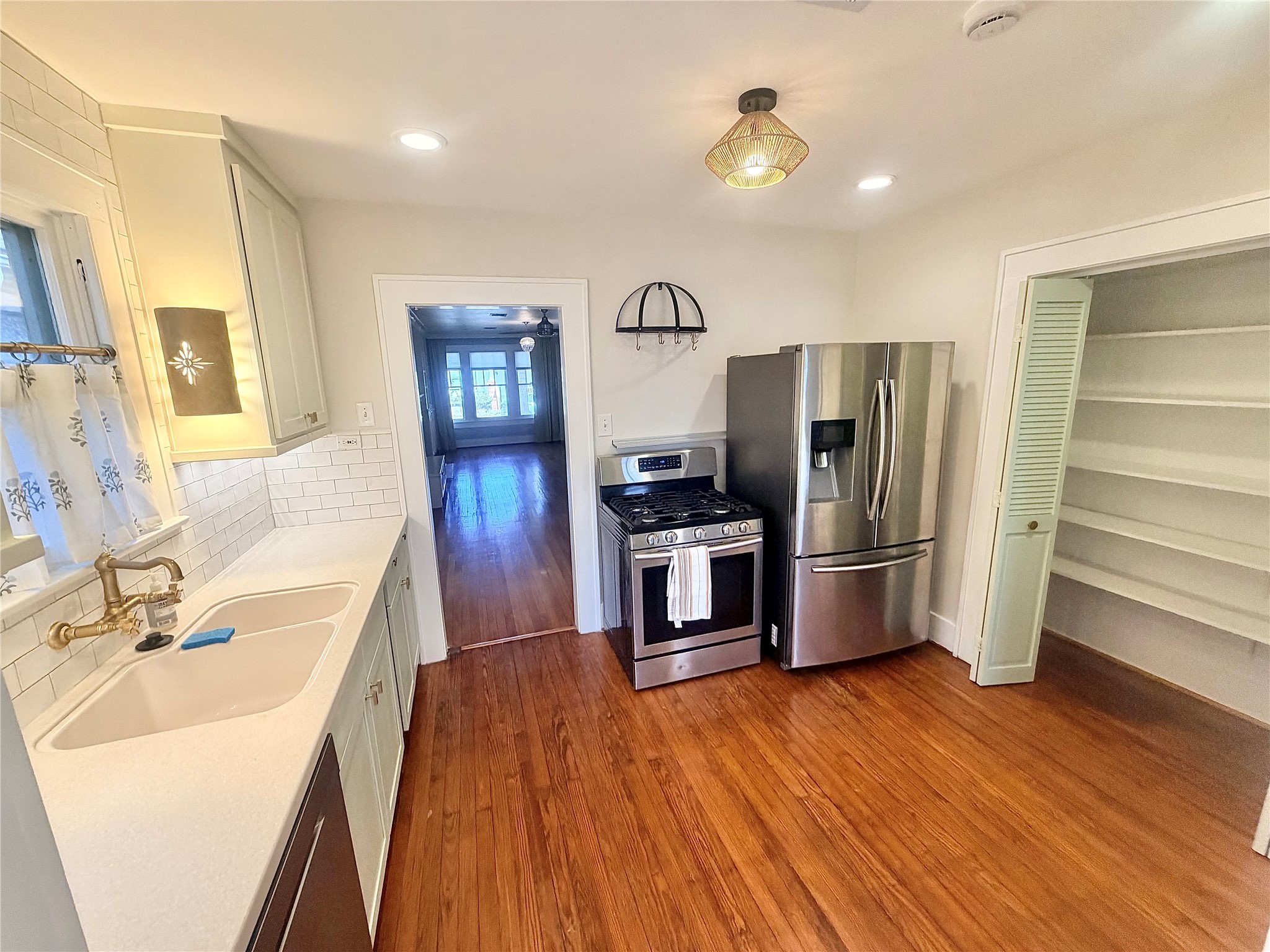 nicely updated open kitchen offers pantry, gas range, refrigerator, and dish washer