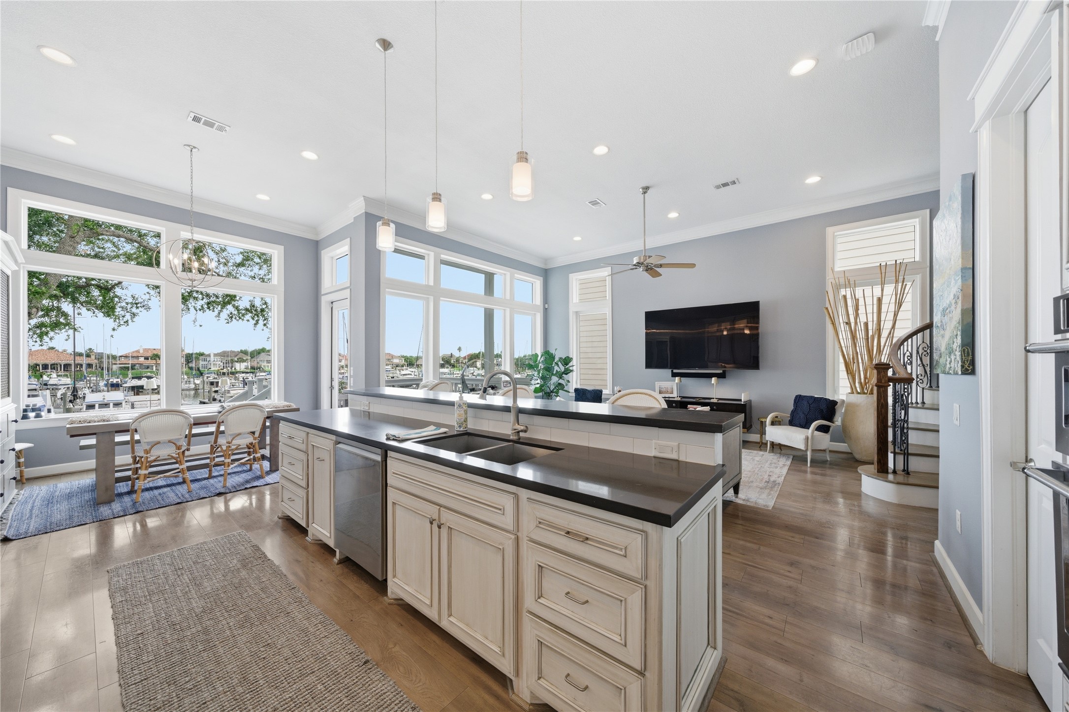 The open concept kitchen/family room has a wall of windows to enjoy the marina view. The open concept kitchen/family room has a wall of windows to enjoy the marina view.