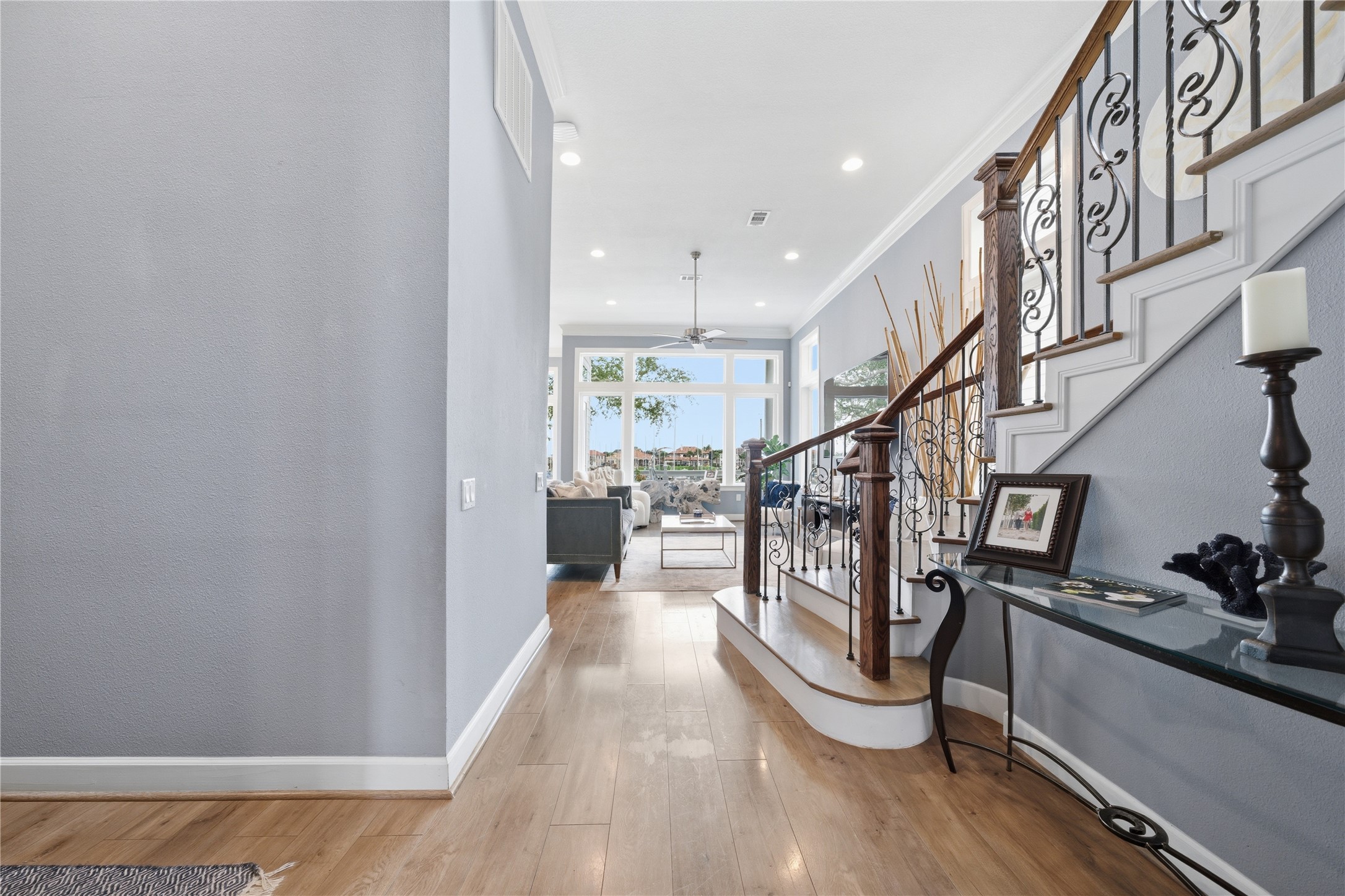 As you head towards the back of the house, you'll pass the beautiful curved staircase before reaching the family room and kitchen.