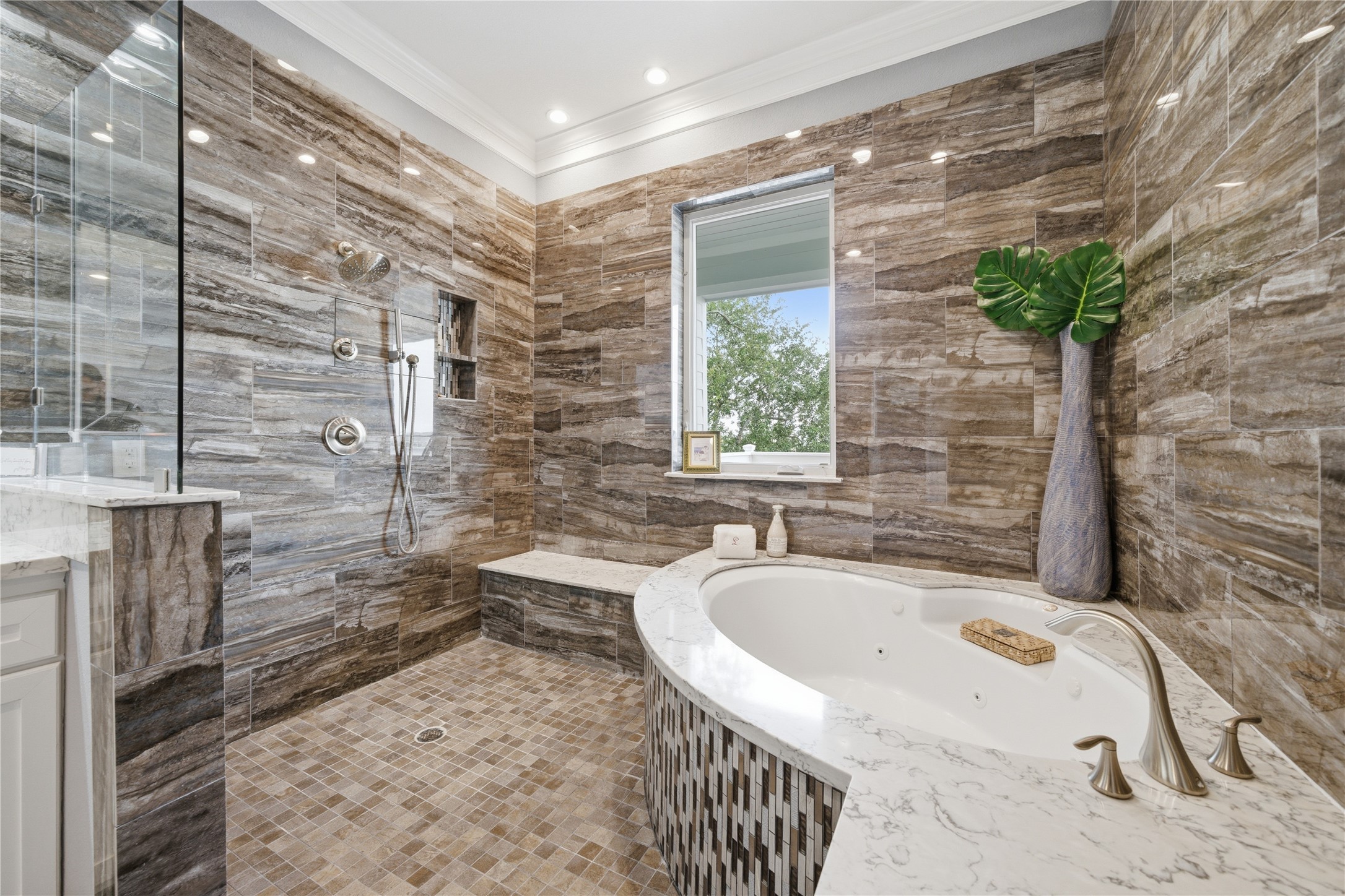 The primary bathroom has a huge walk-in shower, complete with jetted tub. The primary bathroom has a huge walk-in shower, complete with jetted tub.