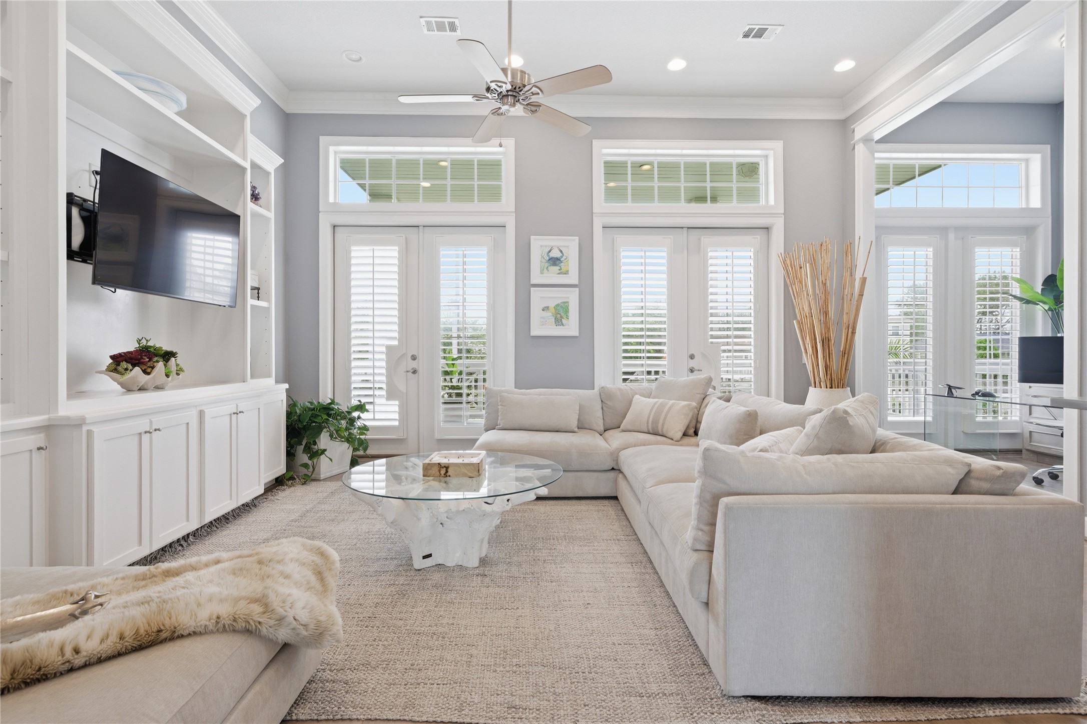 At the front of the house is this flex space that could be a second living area, a game room, or convert it to a 4th bedroom.  Two sets of french doors access the front balcony.  Notice the built-in along the left wall.