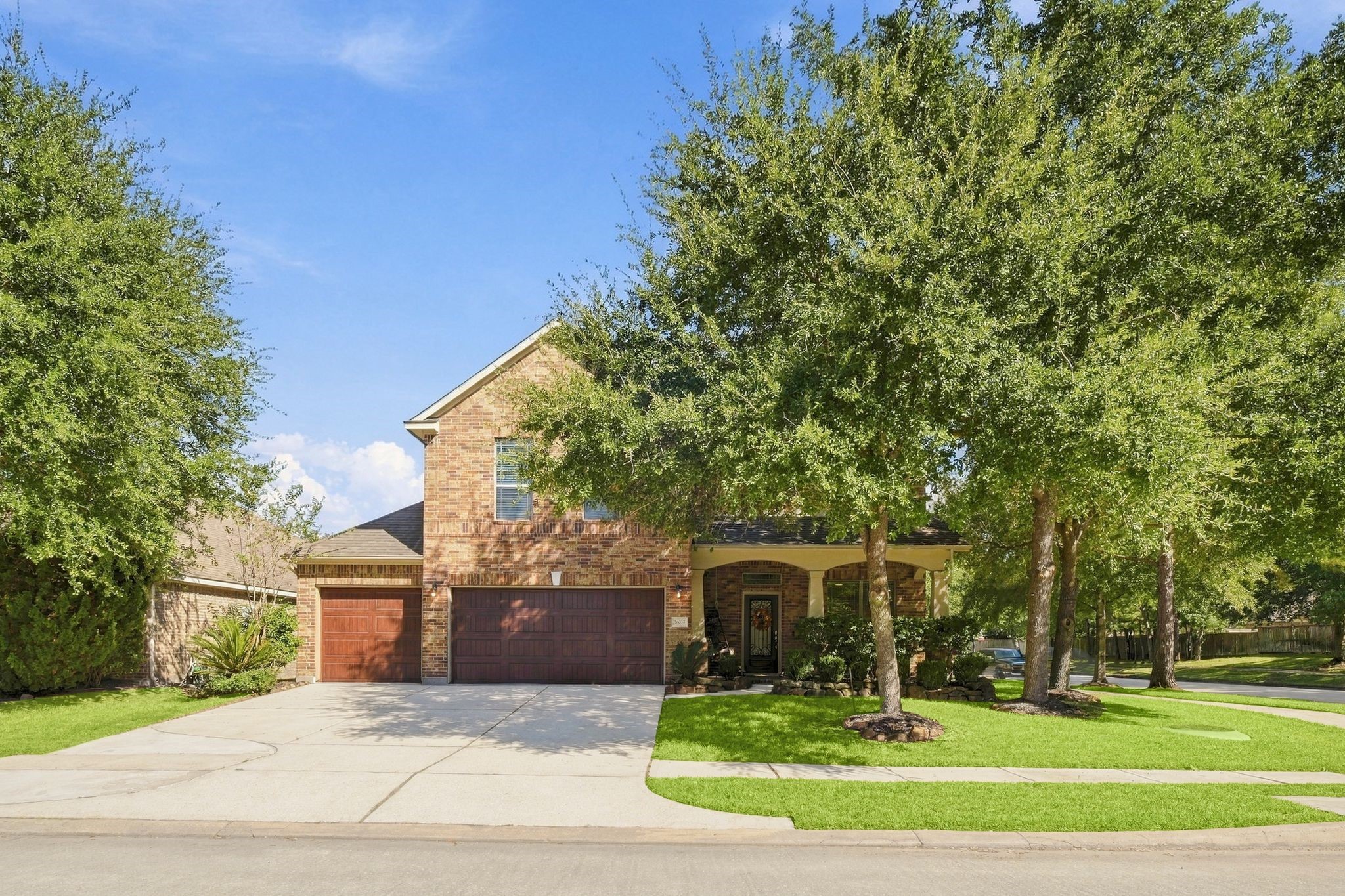 Charming brick home with a spacious three-car garage, nestled among mature trees and complemented by a well-manicured lawn. Charming brick home with a spacious three-car garage, nestled among mature trees and complemented by a well-manicured lawn.