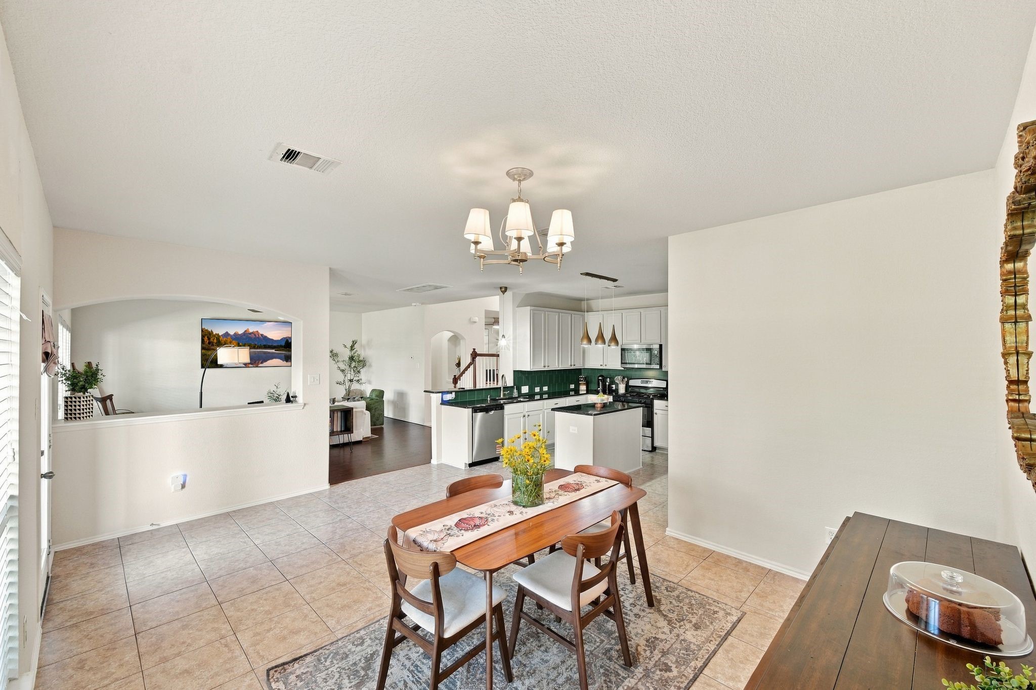 Bright and spacious open-concept living area featuring a modern kitchen with sleek countertops, a cozy dining space, and abundant natural light.