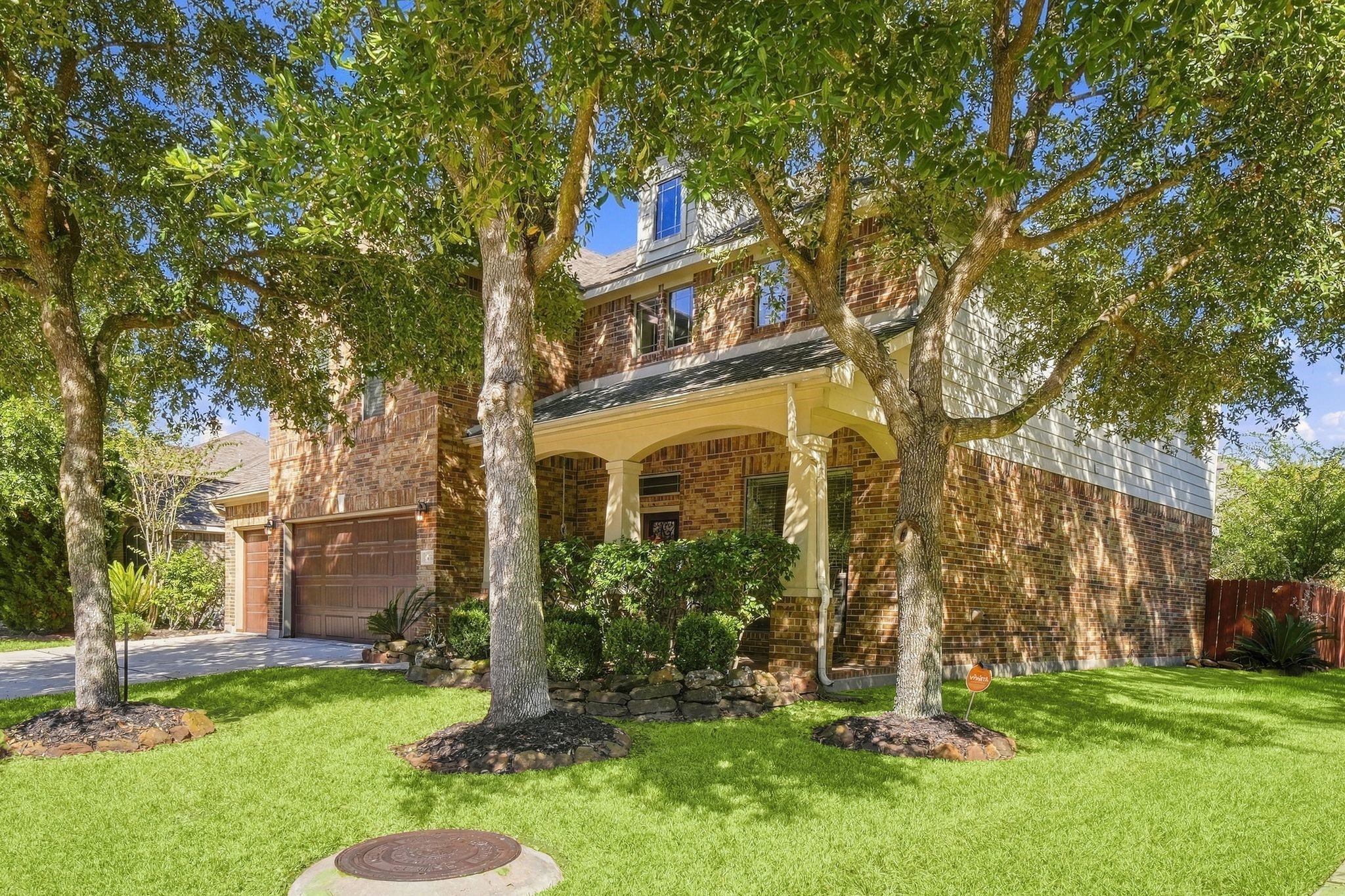 Charming two-story brick home with a welcoming front porch, surrounded by mature trees and lush landscaping, offering ample shade and curb appeal. Charming two-story brick home with a welcoming front porch, surrounded by mature trees and lush landscaping, offering ample shade and curb appeal.