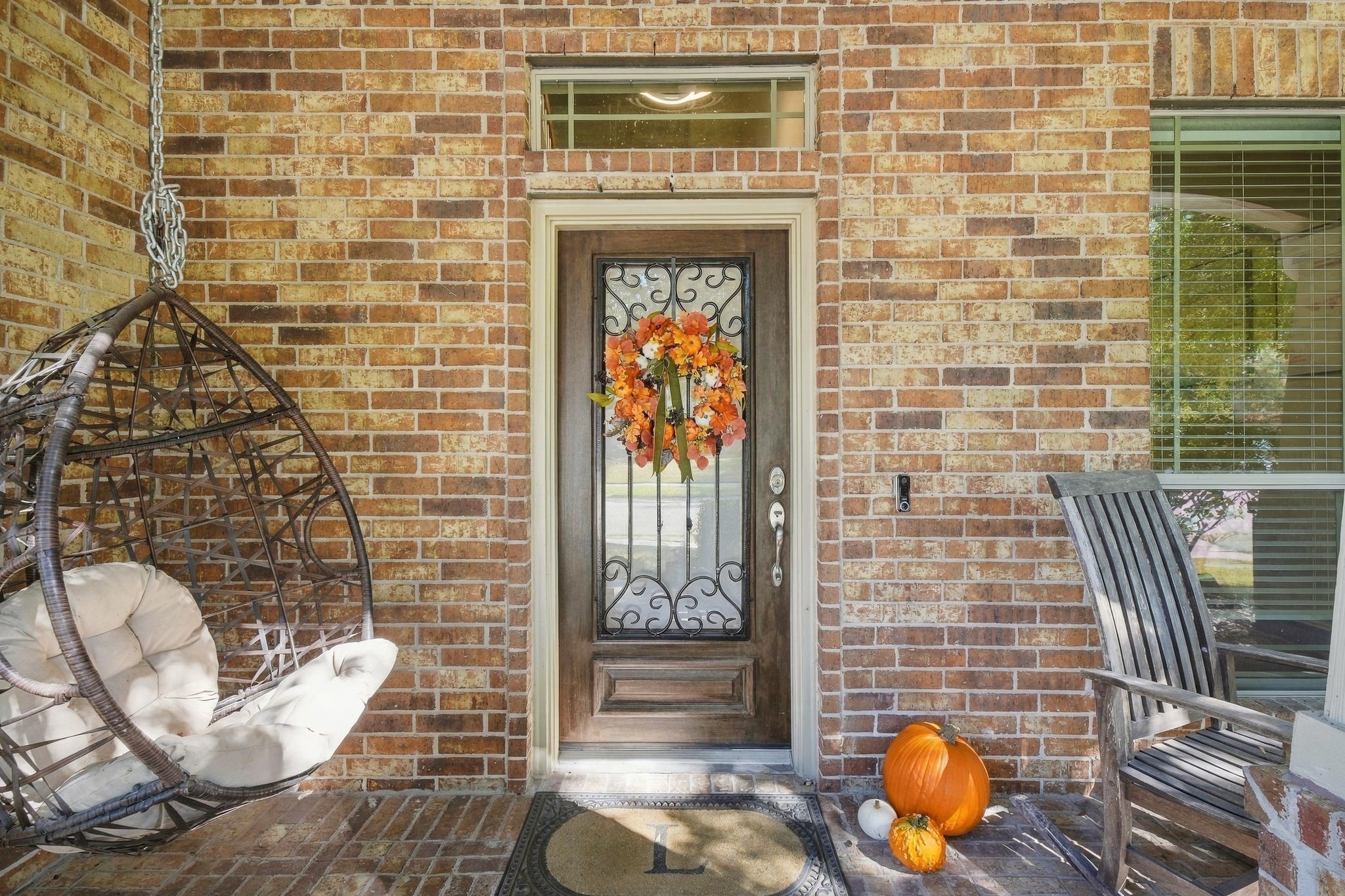 Charming front porch with a brick exterior, featuring a decorative door for a welcoming atmosphere. Charming front porch with a brick exterior, featuring a decorative door for a welcoming atmosphere.