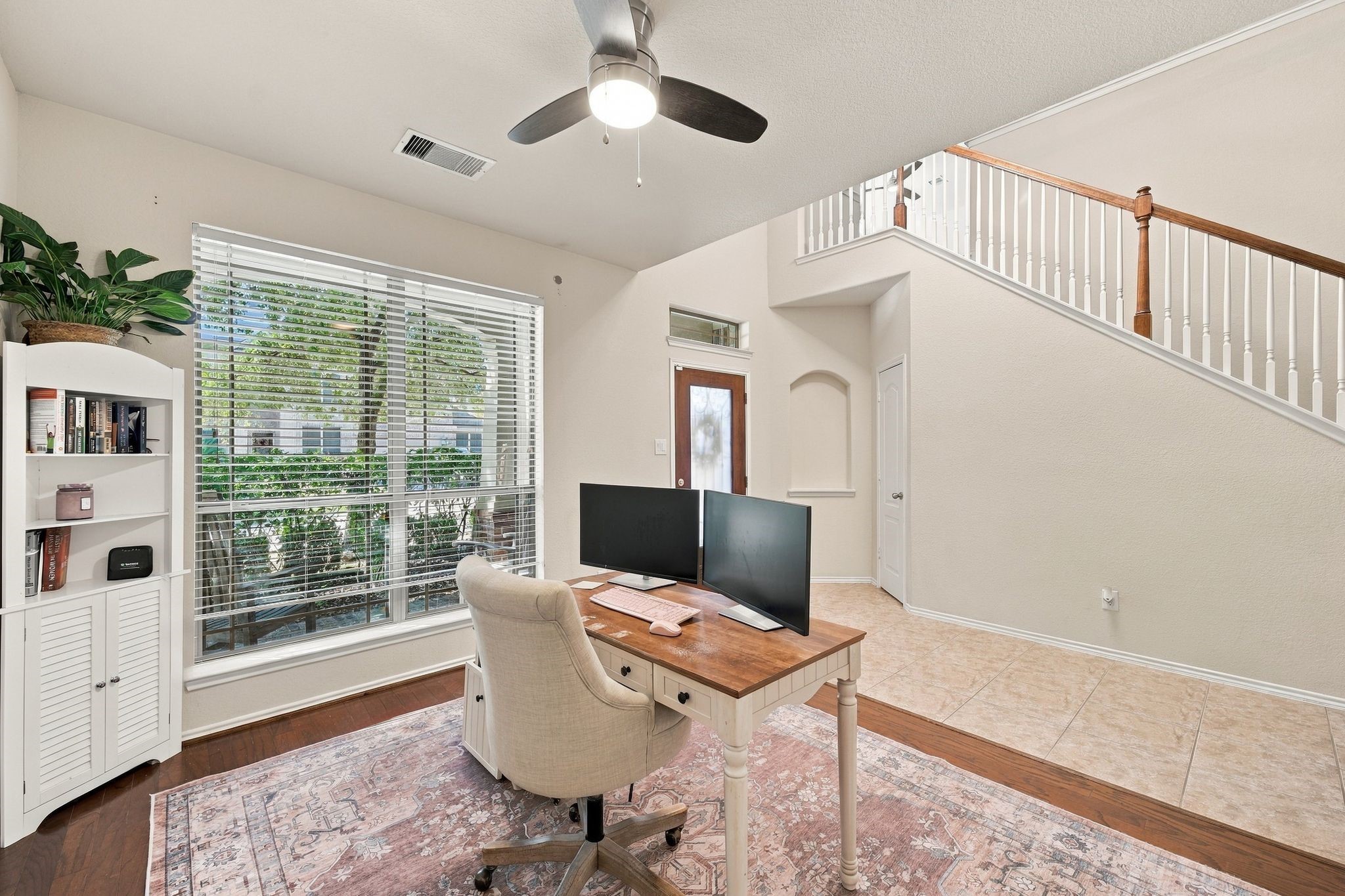 Bright and inviting home office with large windows, elegant flooring, and a stylish staircase, perfect for productivity and comfort. Bright and inviting home office with large windows, elegant flooring, and a stylish staircase, perfect for productivity and comfort.