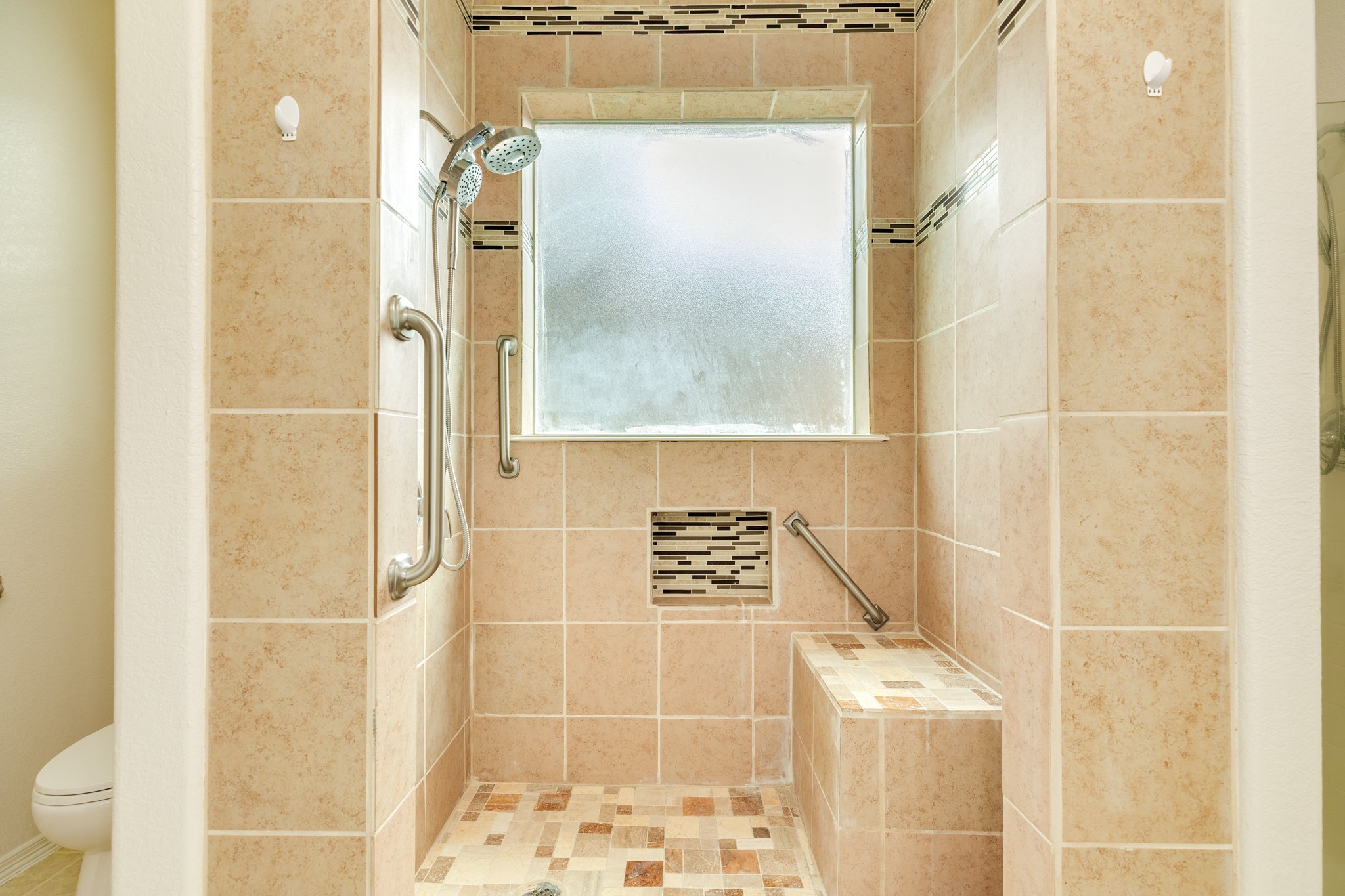 Updated walk in shower in primary bathroom.