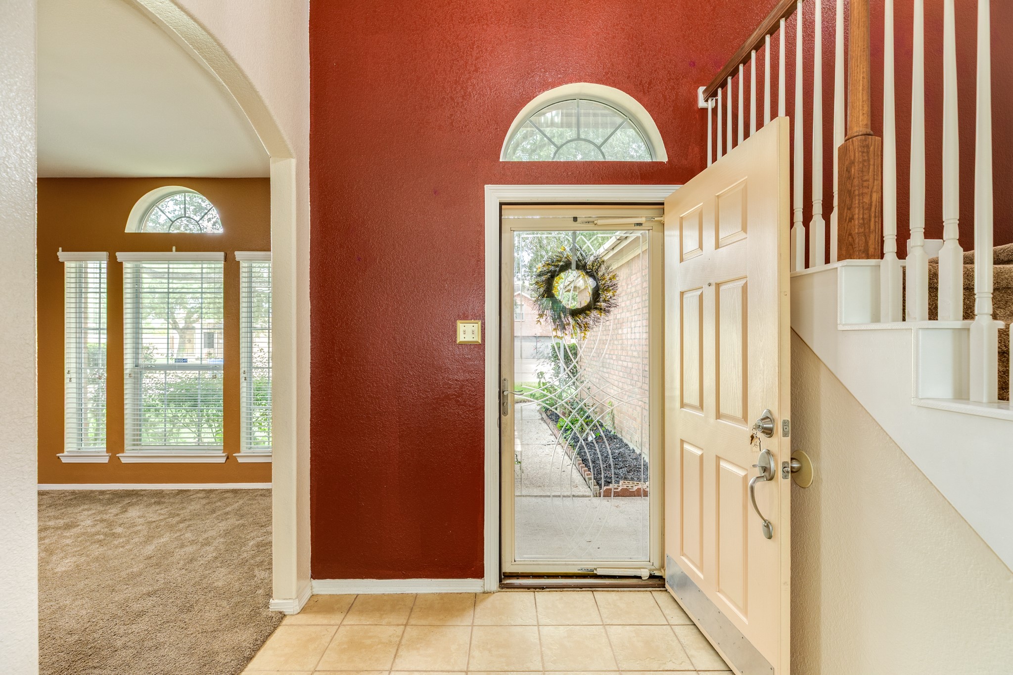 Two story entry way provides a grand entrance and open to living room and dining room.