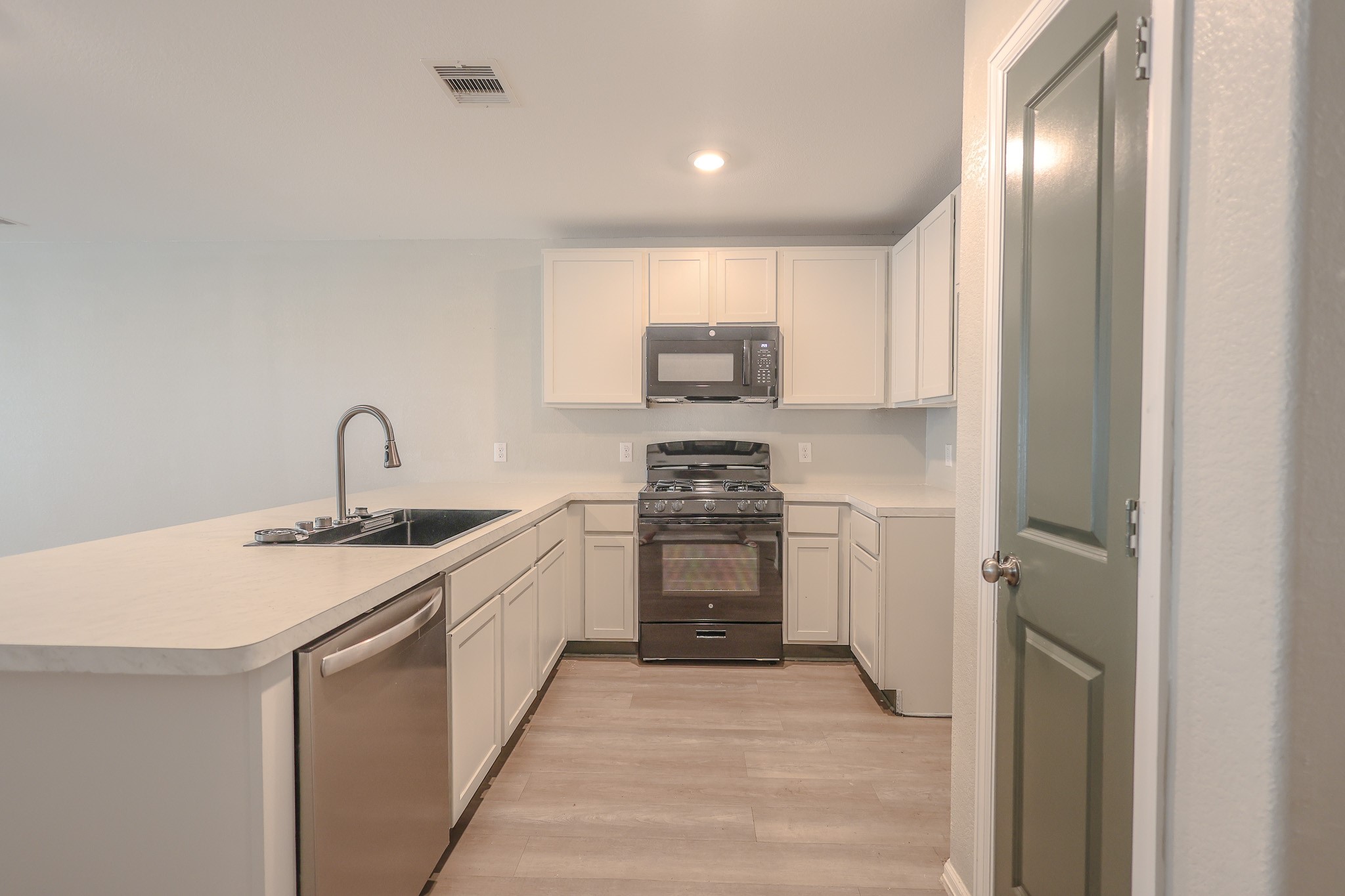 Kitchen with new range and microwave