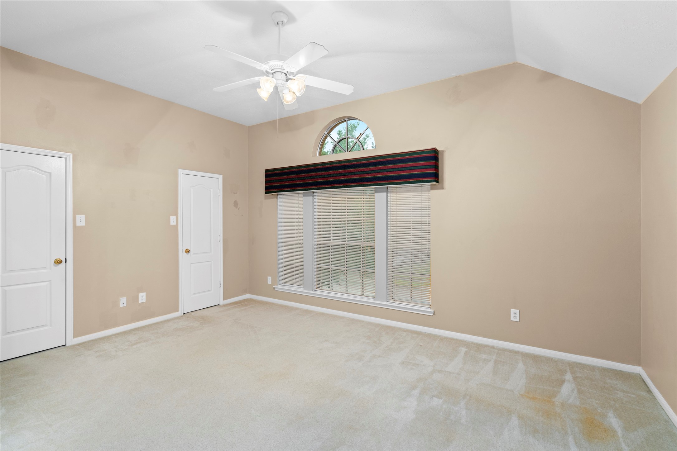 Bright upstairs space with a high ceiling and prominent arched window, offering an excellent blank canvas for personalization. Its flexible character allows a buyer to envision an office, sitting area, play space, or other purpose that fits their lifestyle.