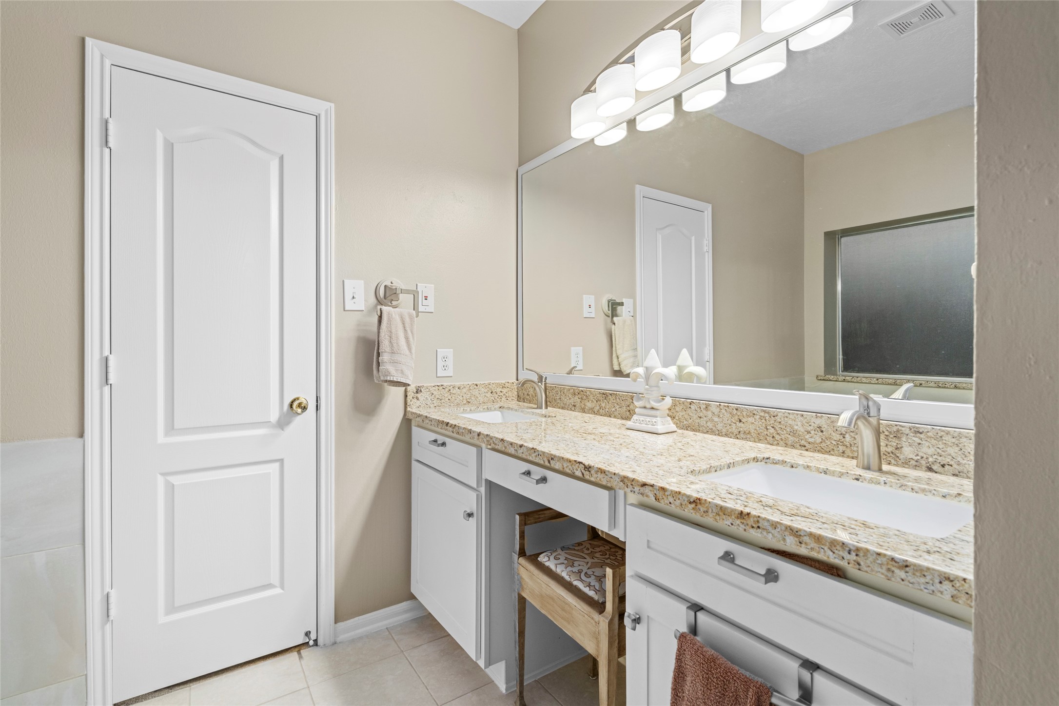 Large dual-sink vanity with generous counter space and storage creates a practical setup for everyday routines. The spacious vanity area complements the home's larger primary suite and provides the functionality buyers often prioritize in a primary bath.