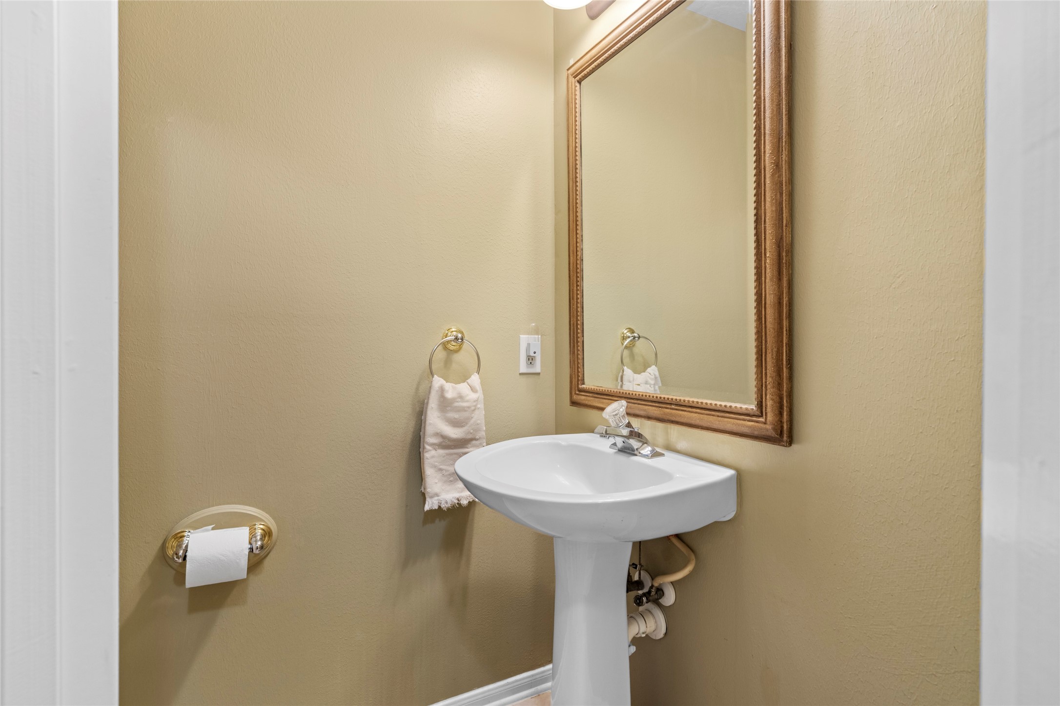 Convenient downstairs powder room positioned for guests, with a clean, functional layout and warm finishes. Its location on the main level adds an important layer of everyday convenience for both residents and visitors.